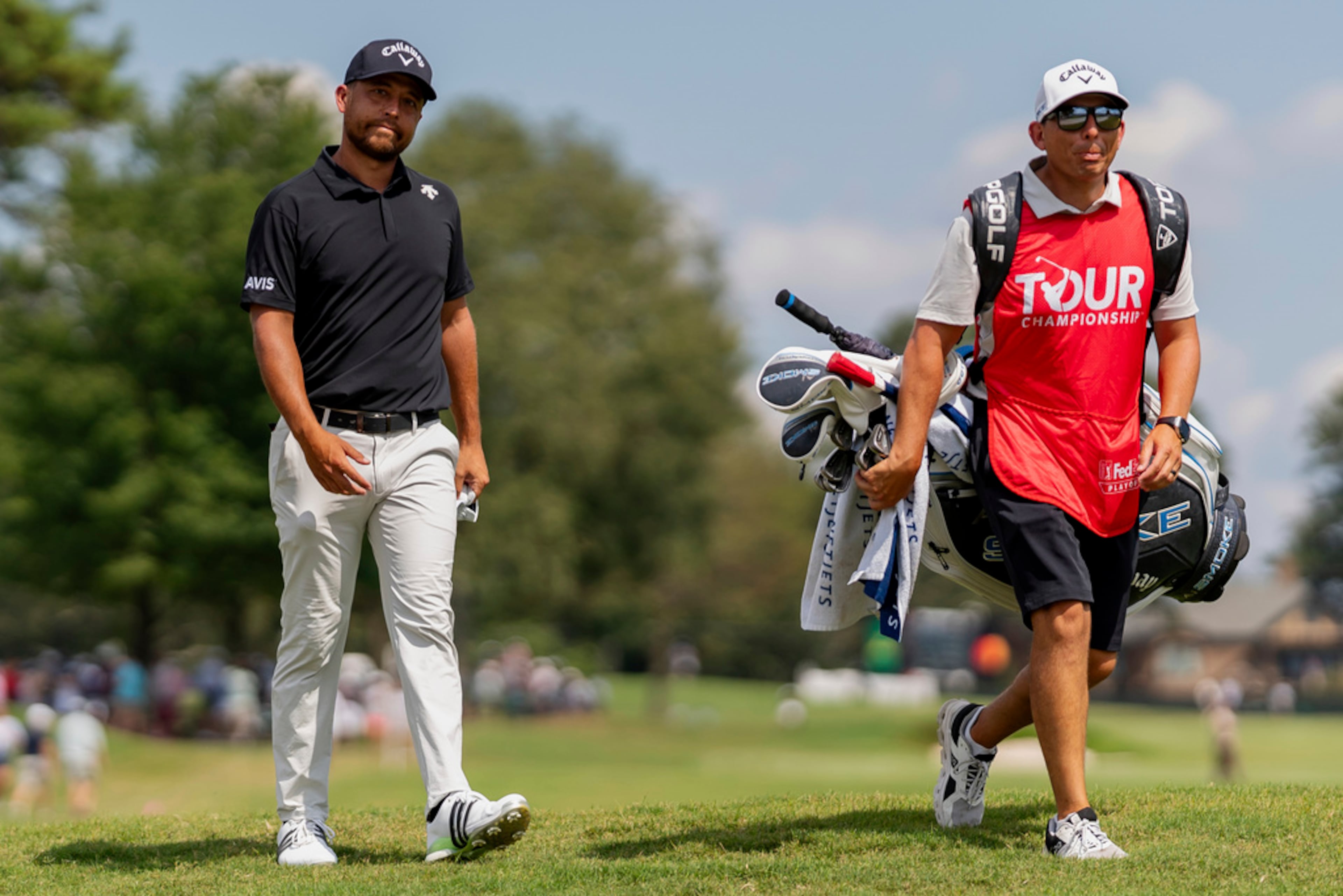 Xander Schauffele and his caddie walk to the tee box at hole number four during the third round of the Tour Championship golf tournament, Saturday, Aug. 31, 2024, in Atlanta. (AP Photo/Jason Allen)