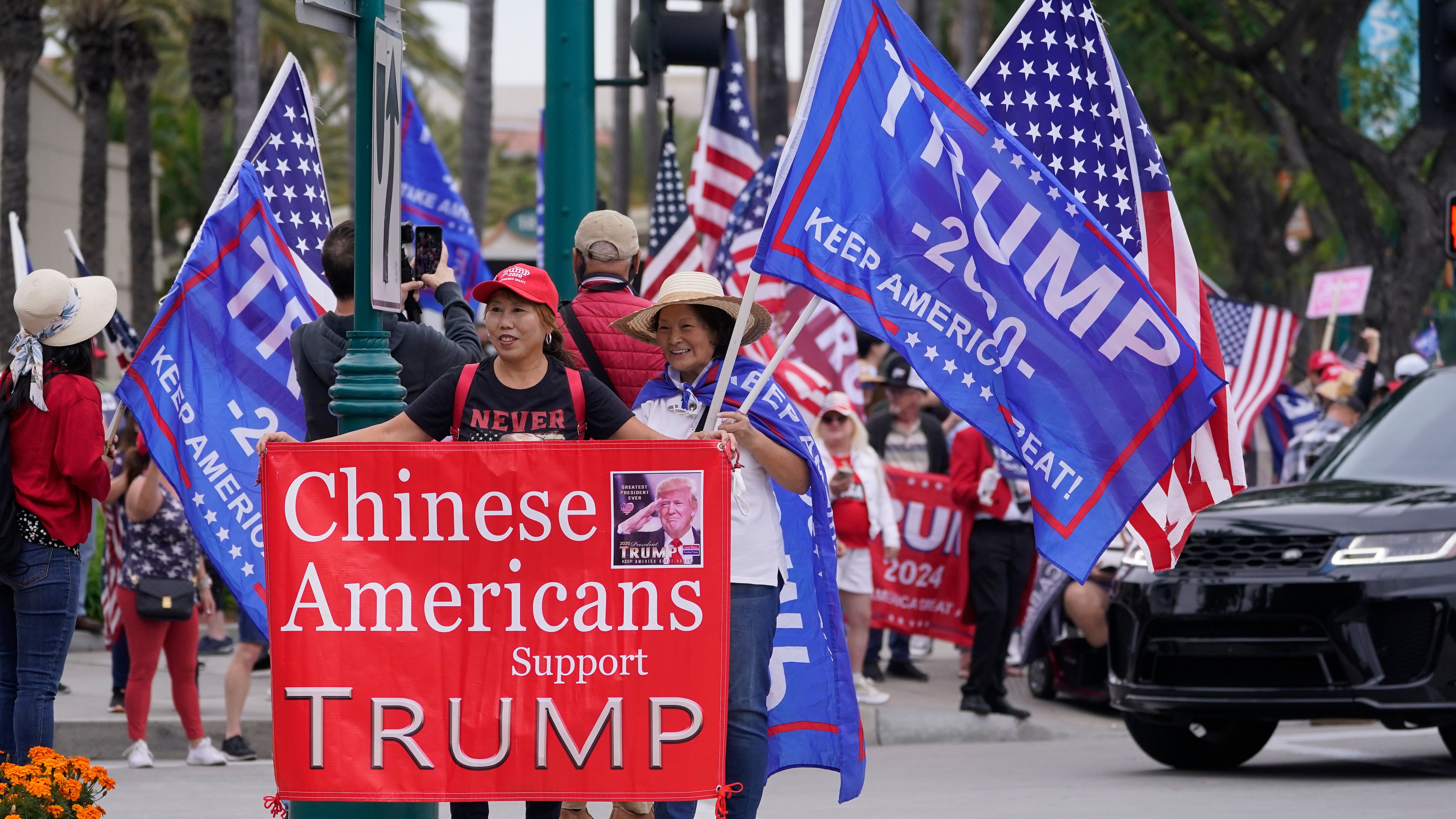 FILE - Chinese Americans supporters of former President Donald Trump stand outside the hotel where the 2023 Fall California Republican Convention is being held in Anaheim, Calif., Sept. 29, 2023. (AP Photo/Damian Dovarganes, File)