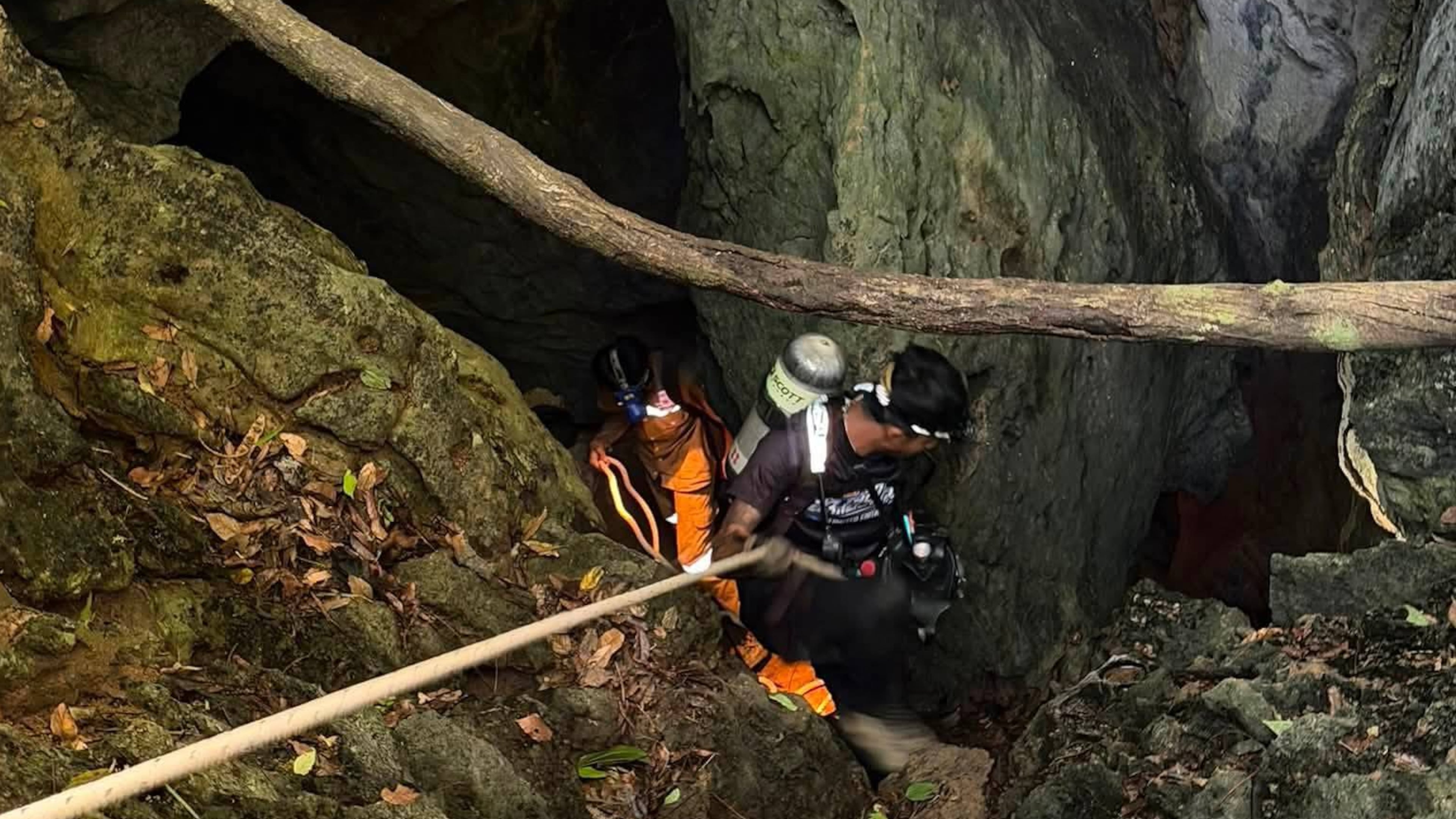 In this image released by Metta Tham Rescue Kalasin, rescuers try to reach people who have been trapped in a cave in Xaisomboun province, Laos, Tuesday, May 26, 2026. (Metta Tham Rescue Kalasin via AP)
