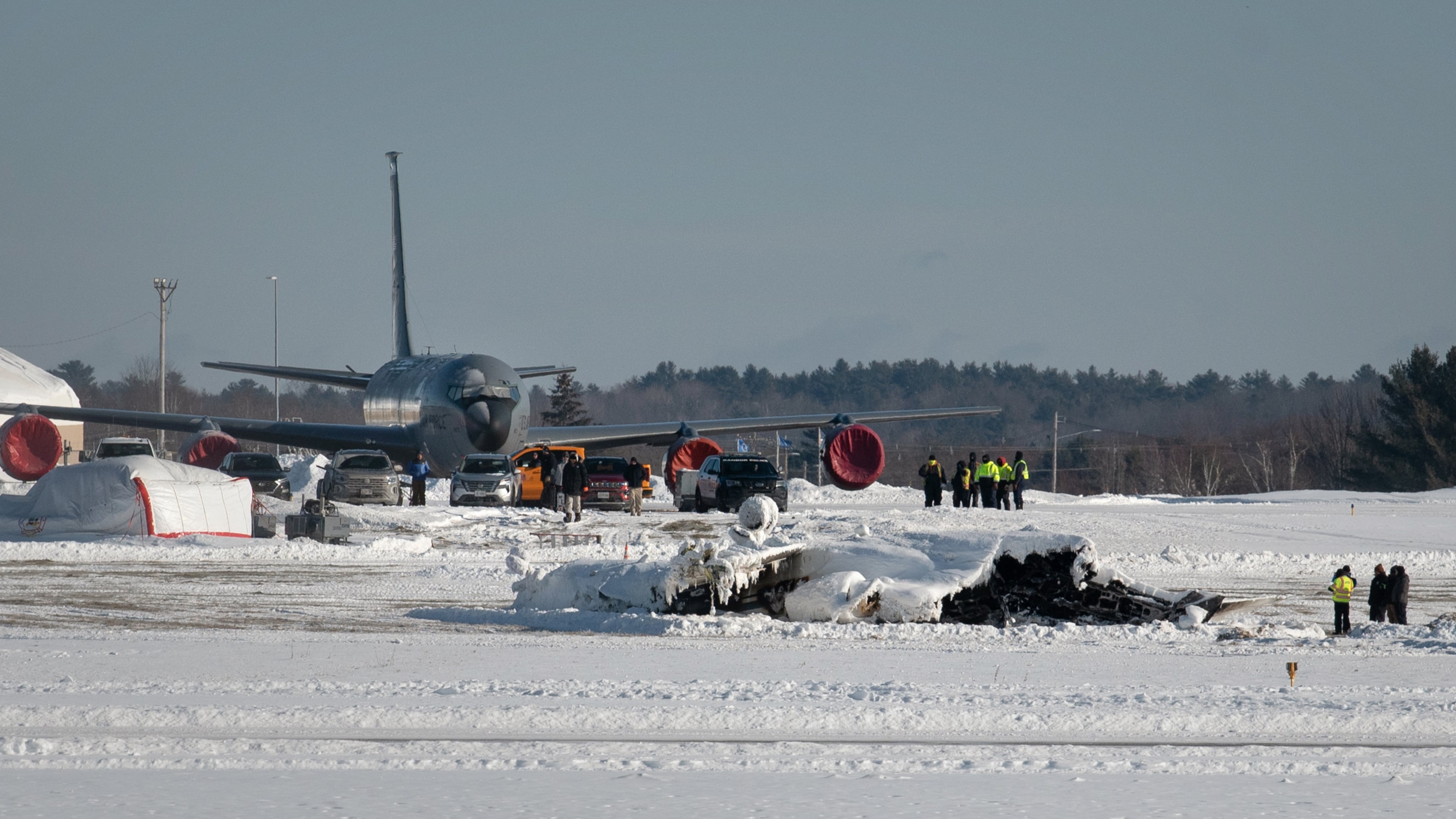 Investigators from the Federal Aviation Administration and National Transportation Safety Board investigate a plane crash at Bangor International Airport Wednesday, Jan. 28, 2026 in Bangor, Maine. (Linda Coan O'Kresik/The Bangor Daily News via AP)