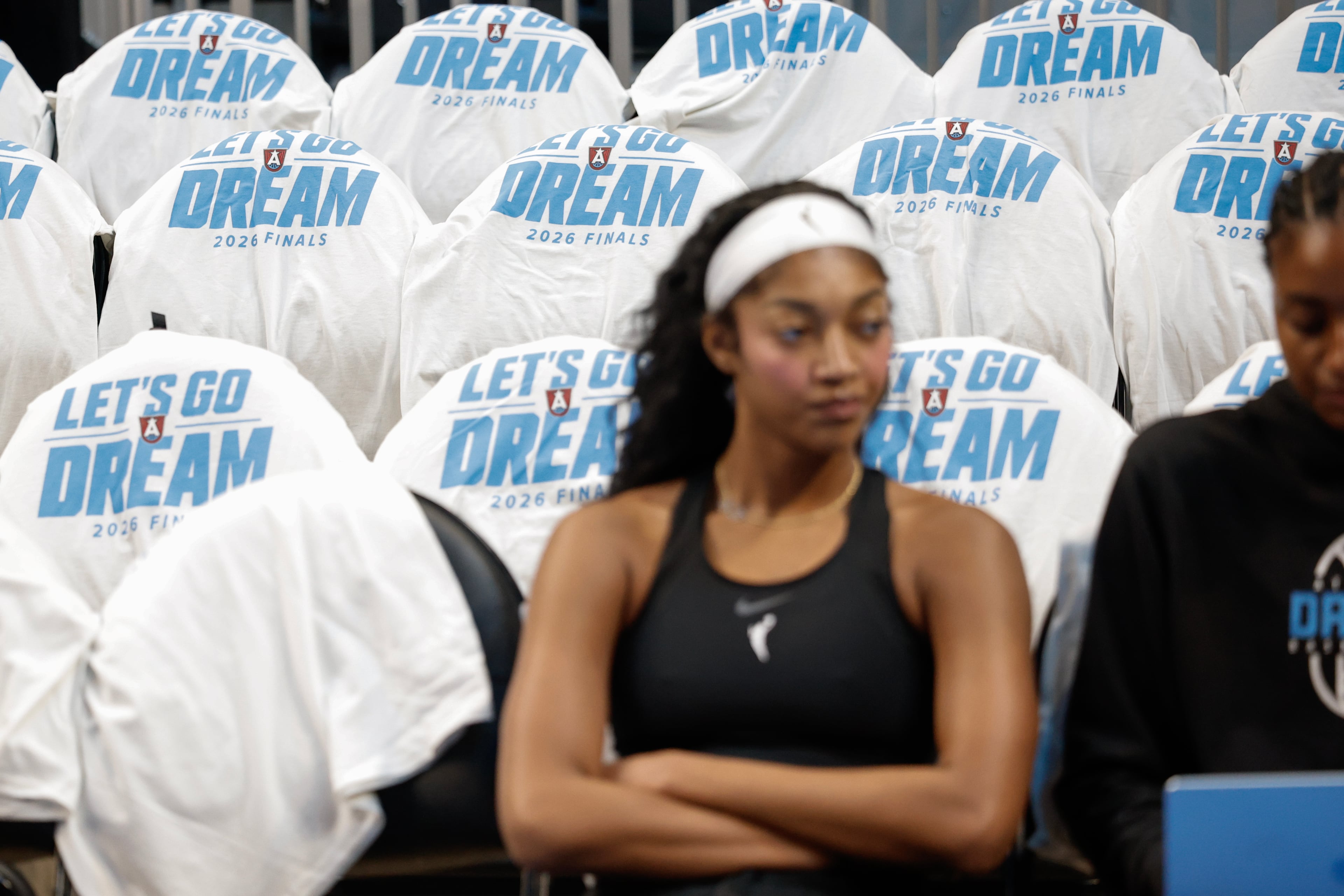 Atlanta Dream forward Angel Reese sitting among the free shirts before Game 4 of the WNBA Finals between the Atlanta Dream and the Golden State Valkyries, Saturday, Oct. 24, 2026, in Atlanta. (Erik S. Lesser for the AJC)