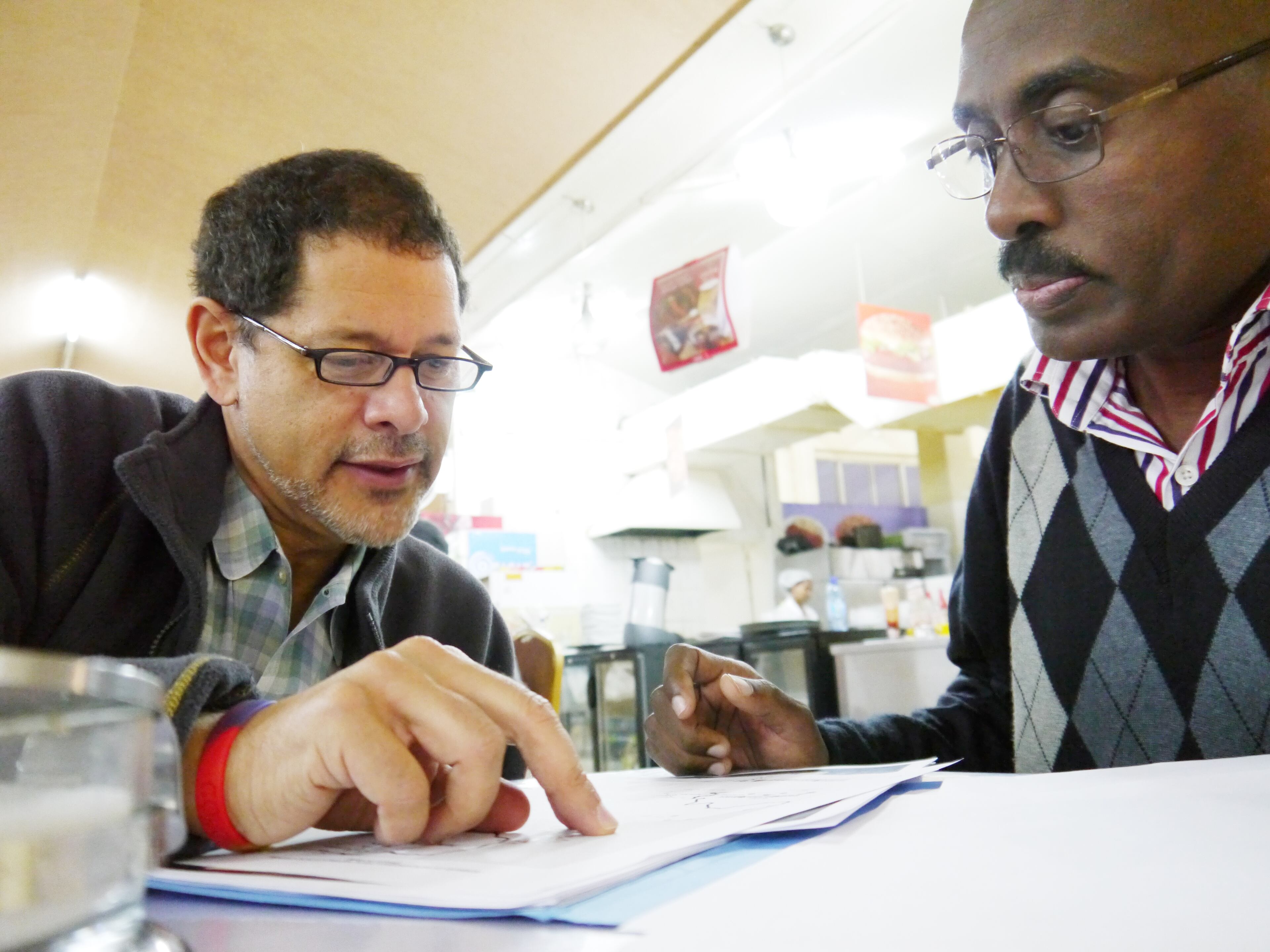 Richards (left) and Aseged Taye, an entomologist for the Carter Center in Ethiopia strategize over a map of the Sudanese border. The two drove through the area to try to determine whether hills along the border were high enough to block the flight of black flies which carry river blindness. Photo by Chris Quinn/cquinn@ajc.com