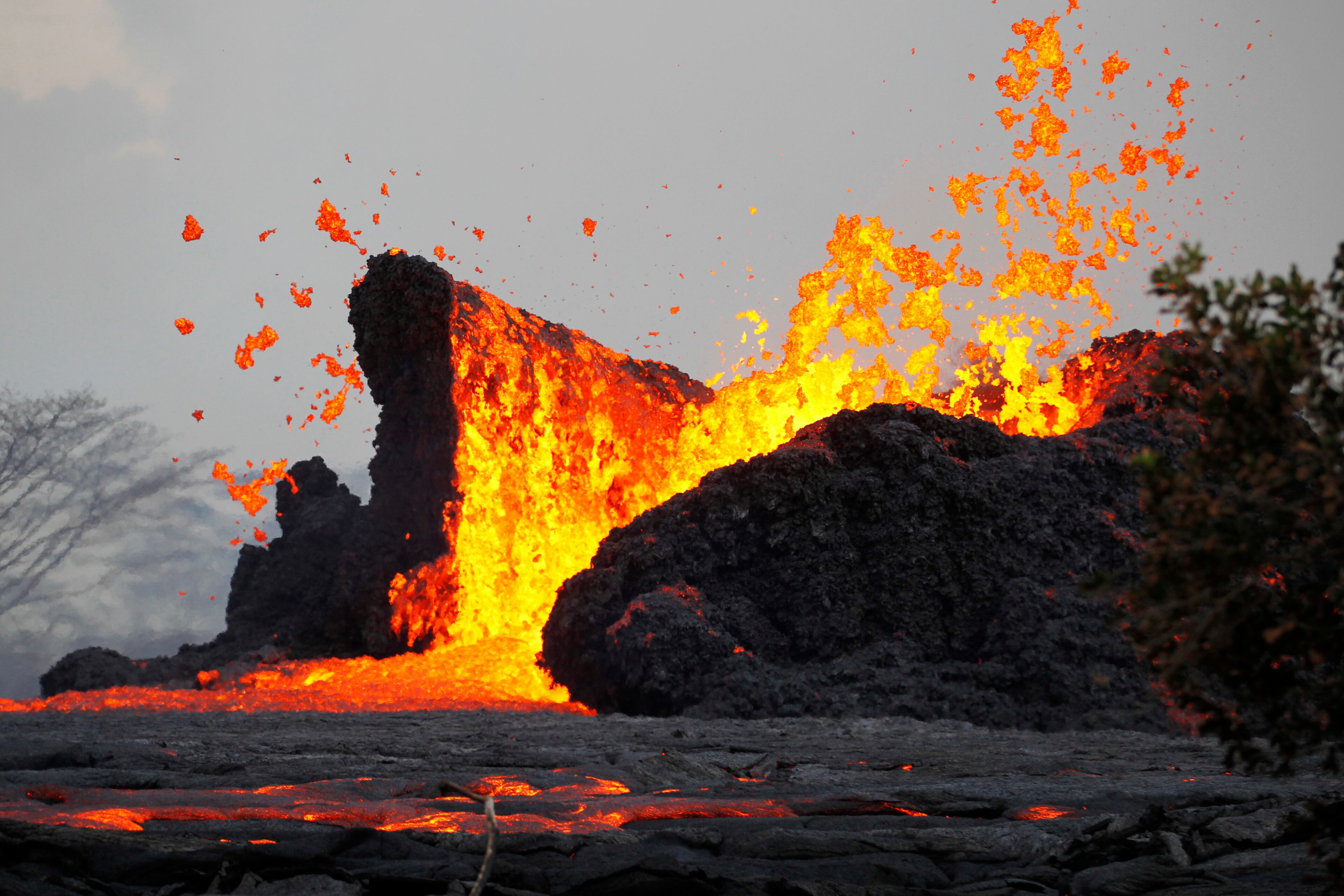 In this May 23, 2018 photo, lava erupts in the air in Leilani Estates area near Pahoa, Hawaii. The Kilauea volcano has opened more than 20 vents in the ground that have released lava, sulfur dioxide and steam. (George F. Lee/Honolulu Star-Advertiser via AP)