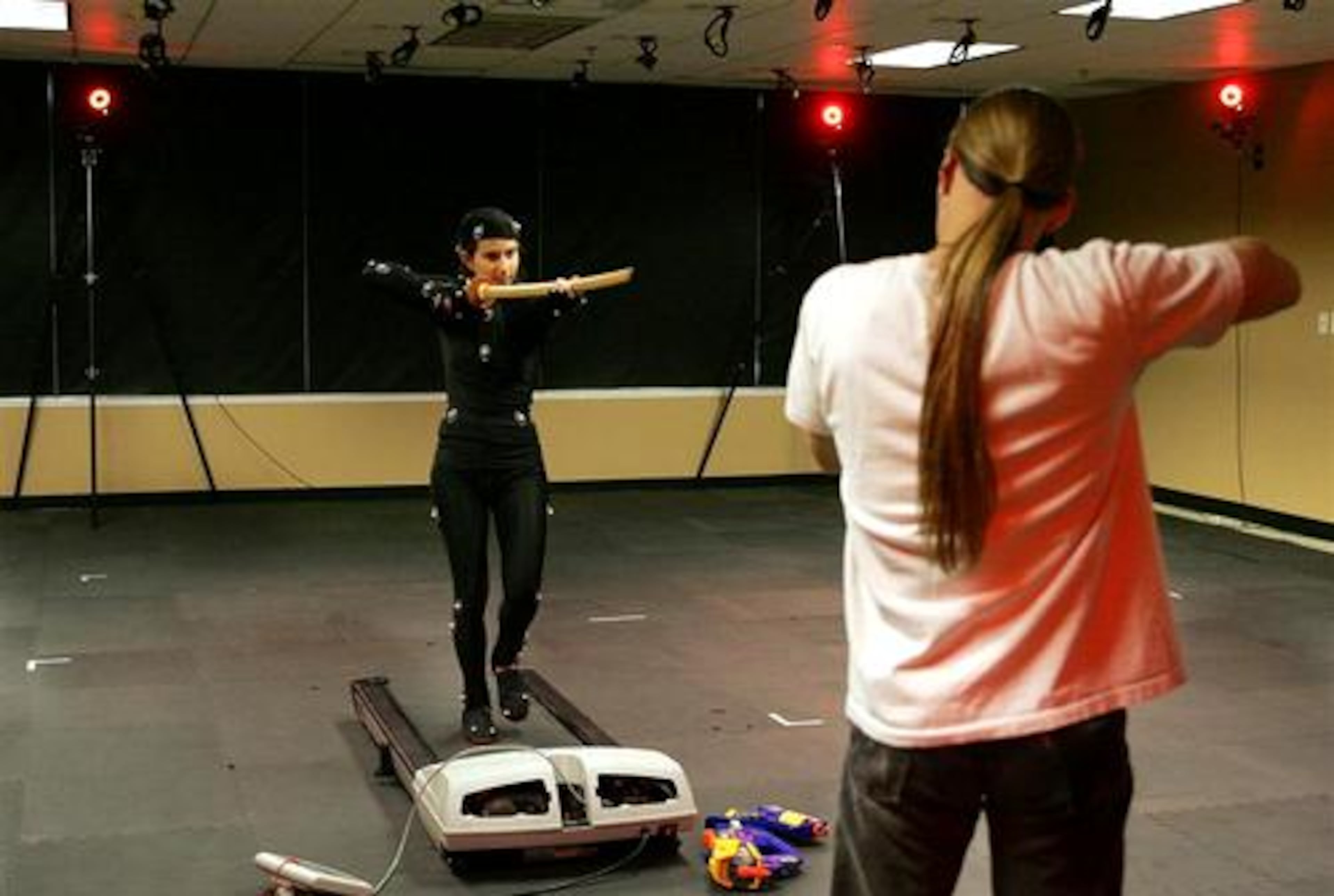 Daniel Lilleberg(right)works with Michal Adam during a motion capture session at Hi-Rez Studios in Alpharetta. Adam dressed in a costume with "markers" on it for video used in computer animation. Multiple cameras around the room capture the "markers" on Adam to create a three dimensional image.