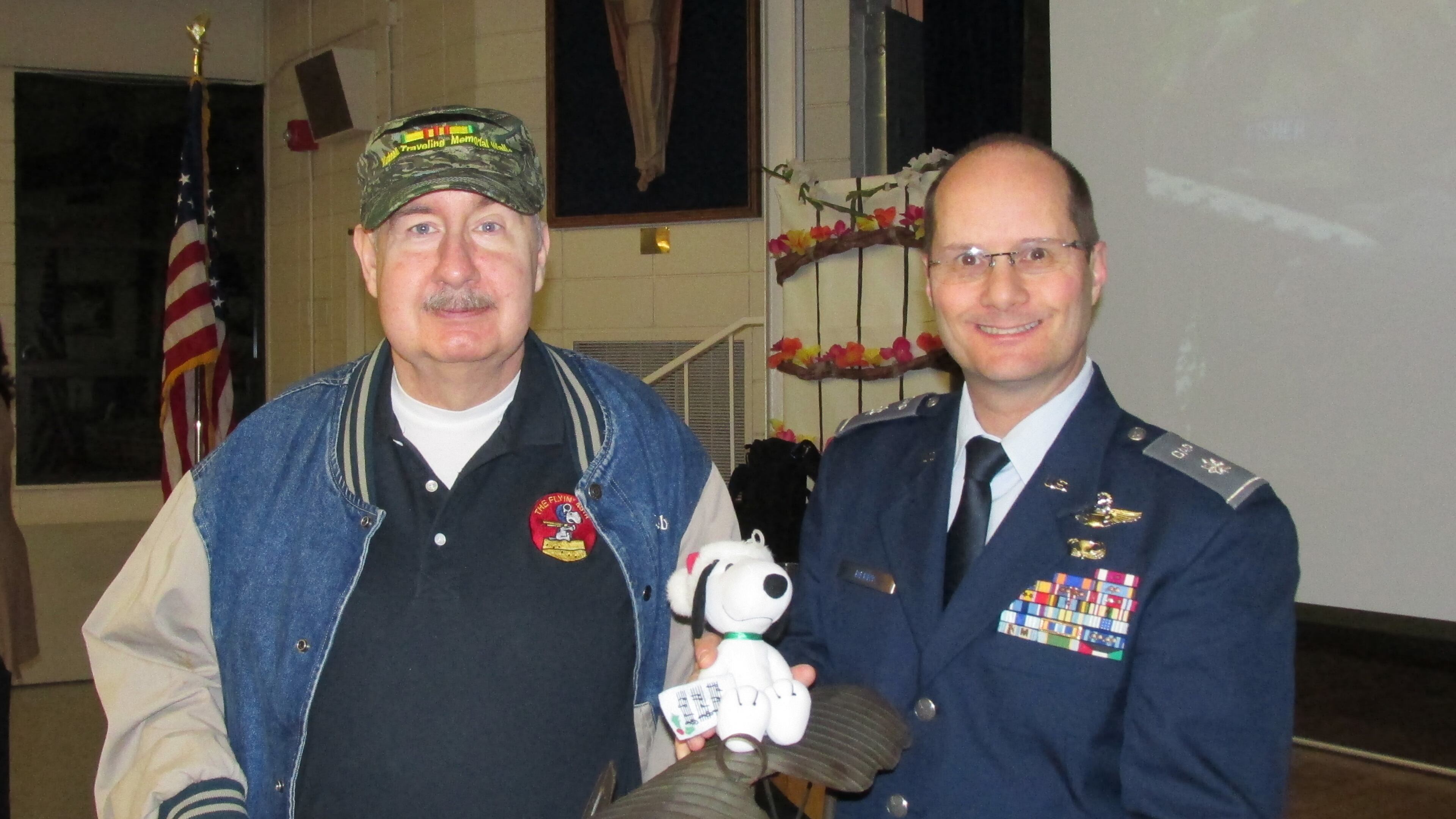 Vietnam War veteran Joe Congleton (left) and Lt. Col Brian Berry show off the model of a World War I plane piloted by the cartoon character Snoopy. The Sandy Springs Cadet Squadron of the Civil Air Patrol presented it to Congleton, who designed the squadron s Snoopy-themed patch in 1967.