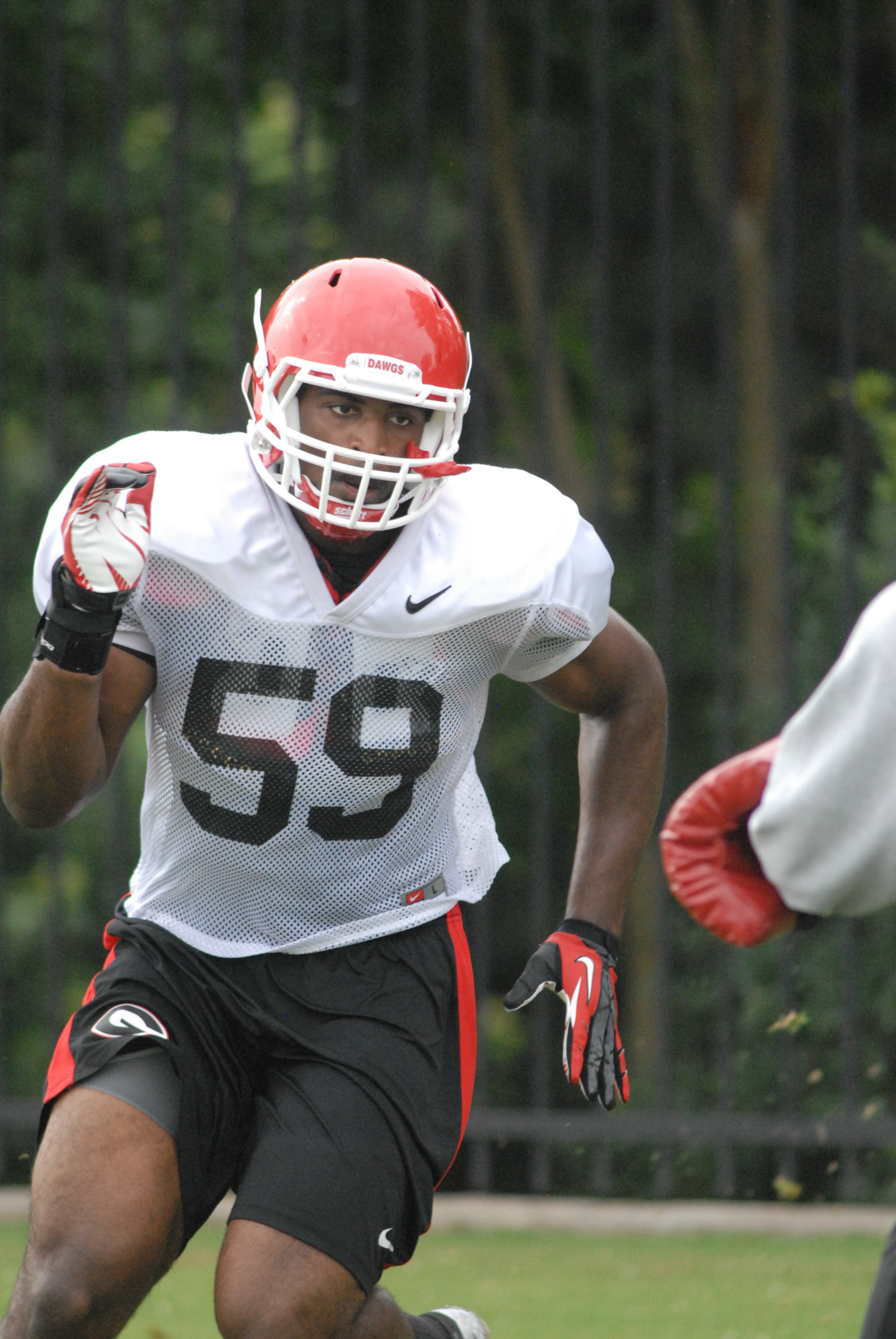 Linebacker Jordan Jenkins (59) goes through a drill during Georgia's practice Thursday, Aug. 8, 2013, in Athens, Ga. (Photo by Steven Colquitt)