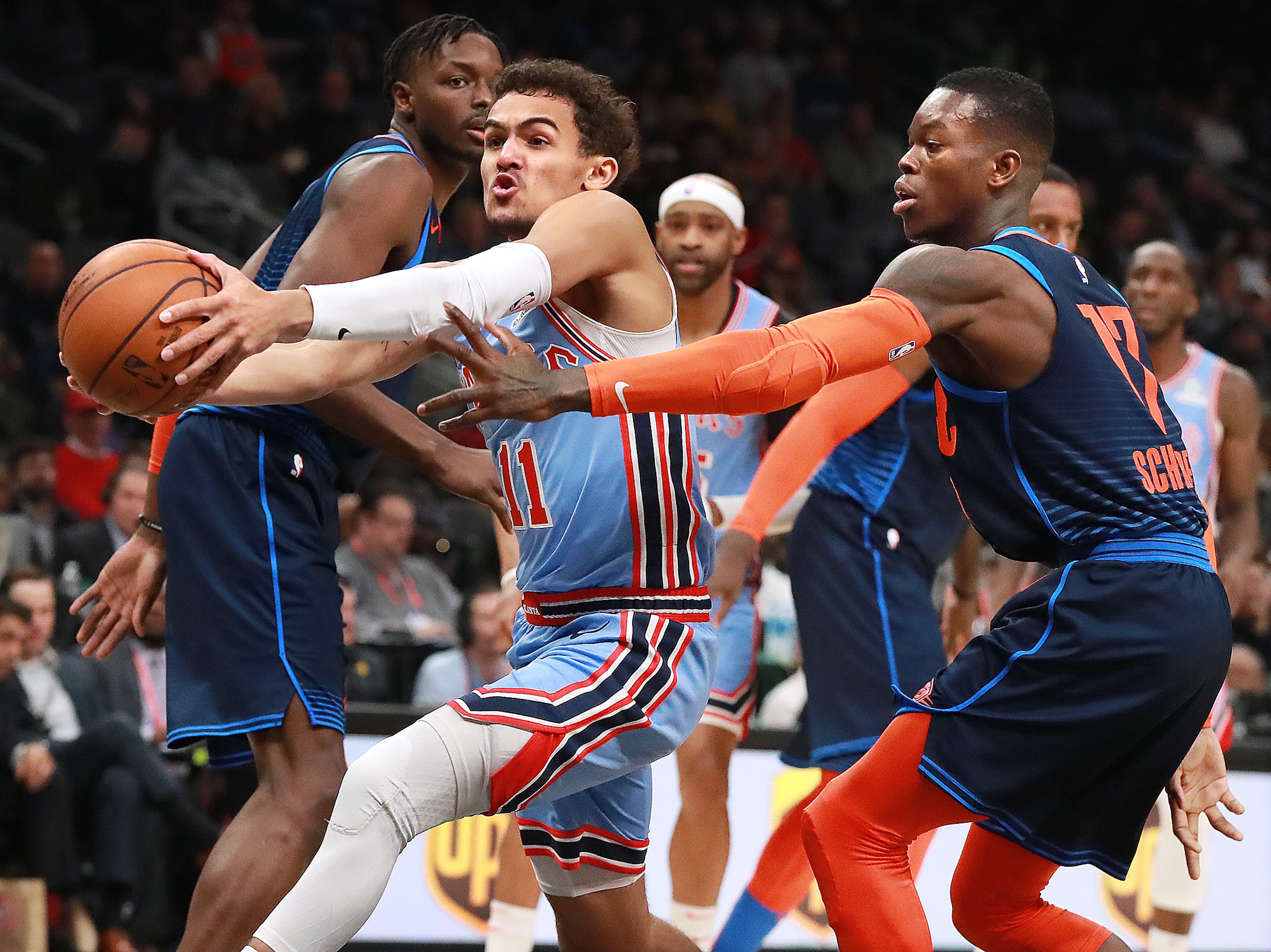 Jan. 15, 2019 Atlanta: Atlanta Hawks guard Trae Young drives to the basket past Oklahoma City Thunder guard Dennis Schroder during the first half in a NBA basketball game on Tuesday, Jan. 15, 2019, at State Farm Arena in Atlanta. Curtis Compton/ccompton@ajc.com
