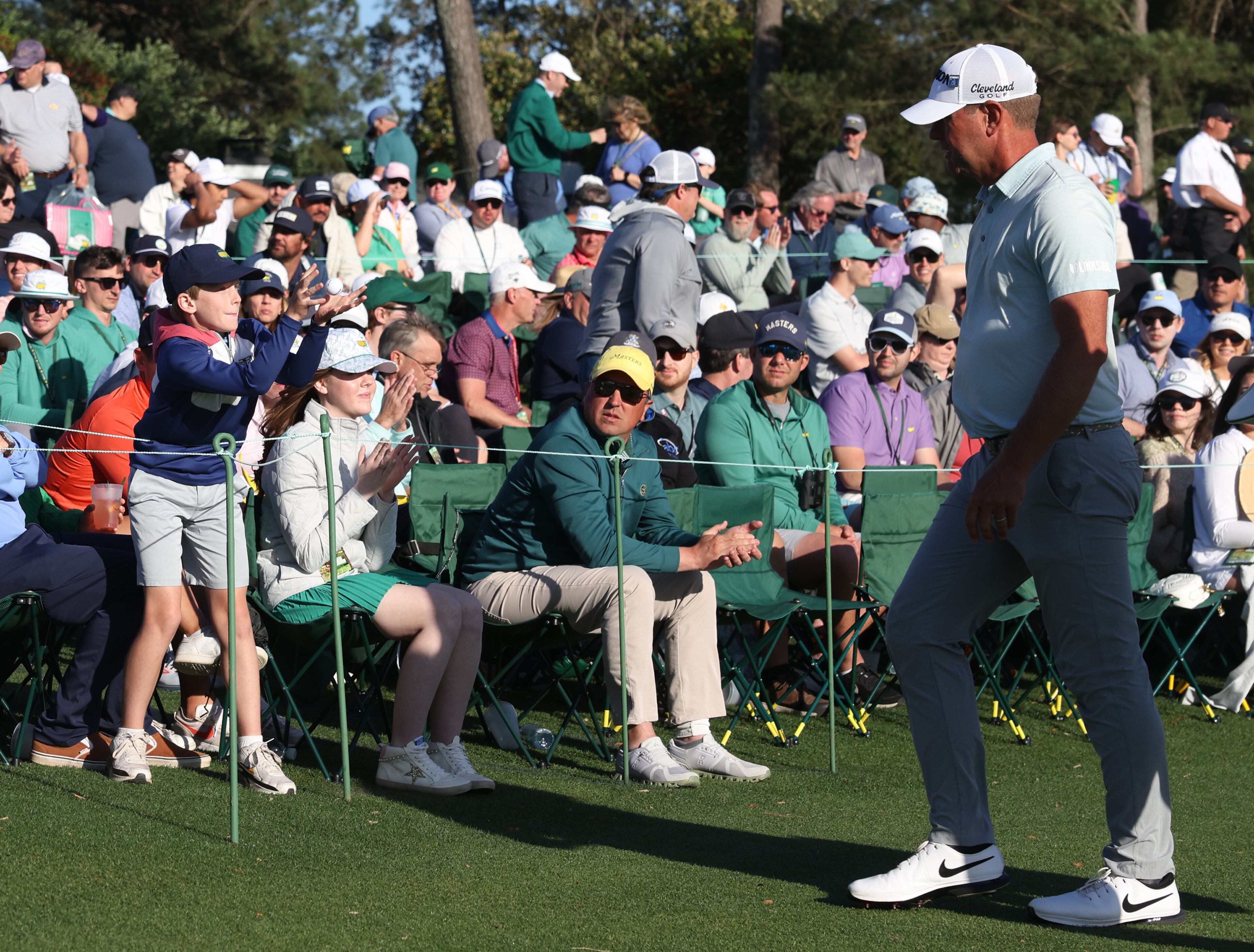 A young fan gets a golf ball from Harris English after finishing his round on 18 during second round of the 2024 Masters Tournament at Augusta National Golf Club, Friday, April 12, 2024, in Augusta, Ga. Jason Getz / Jason.Getz@ajc.com)