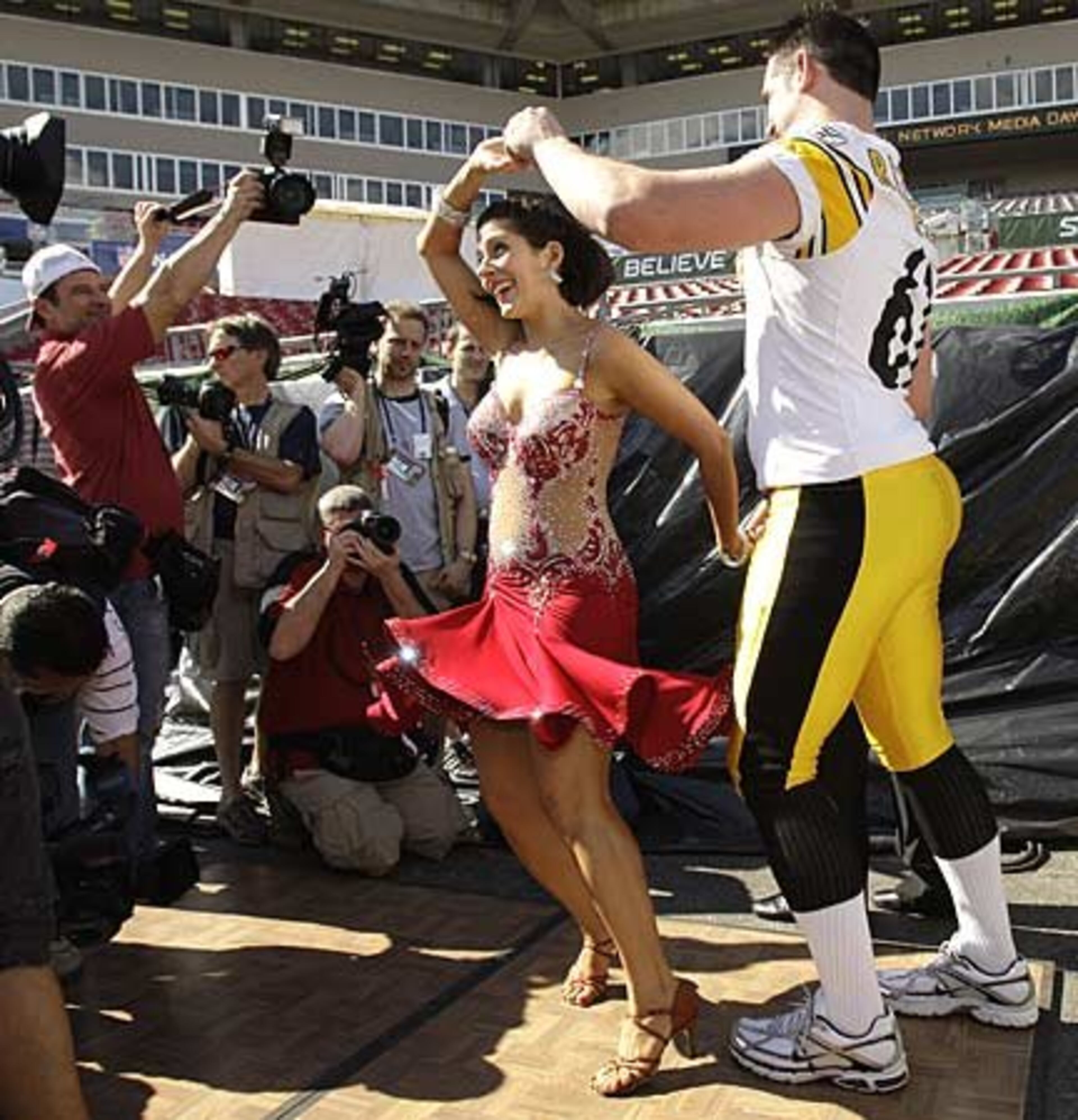 Renee Sapp dances with Steelers defensive end Kyle Clement.