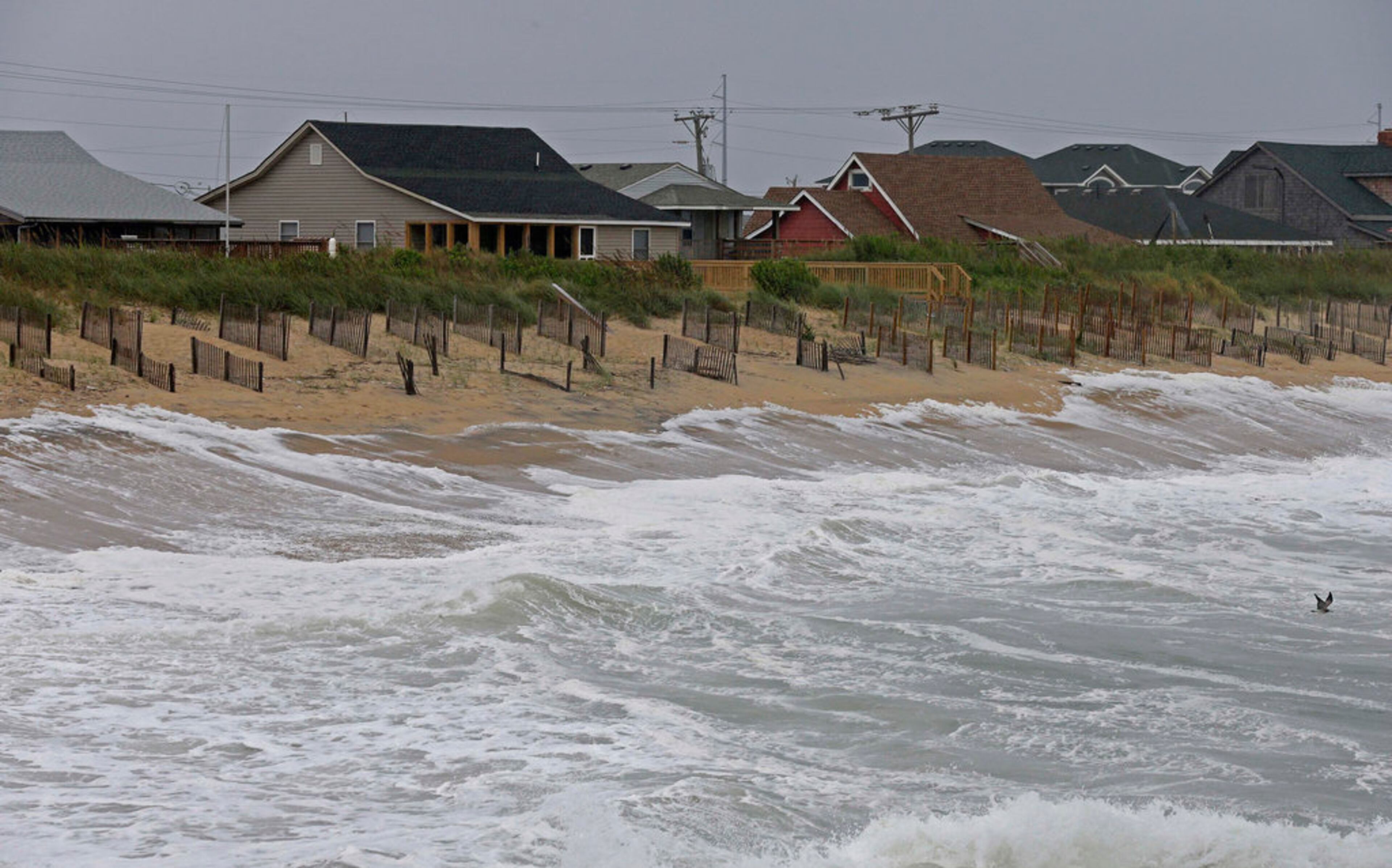 Rising tides move closer to the dunes in Kill Devil Hills, N.C., Thursday, Sept. 13, 2018 as Hurricane Florence approaches the east coast. (AP Photo/Gerry Broome)