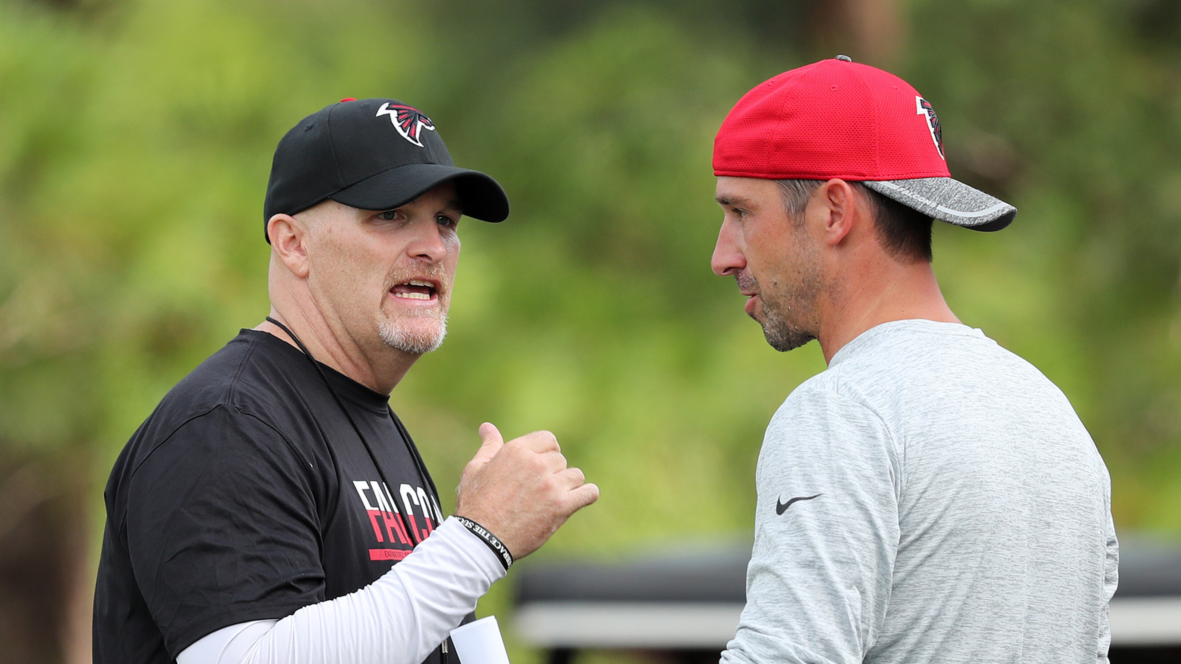 072816 FLOWERY BRANCH: Falcons head coach Dan Quinn confers with offensive coordinator Kyle Shanahan during the first day of training camp on Thursday, July 28, 2016, in Flowery Branch. Curtis Compton /ccompton@ajc.com