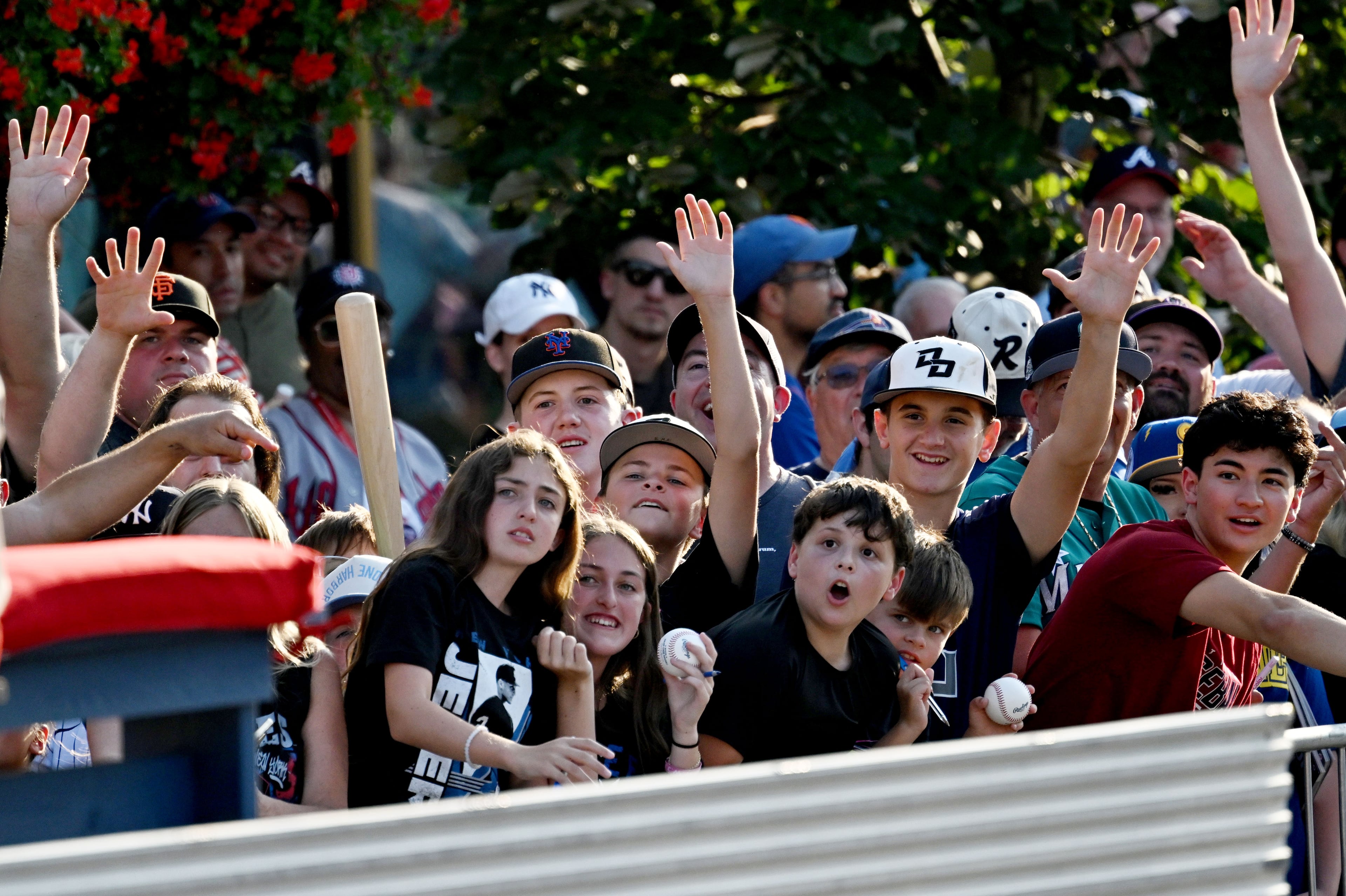 Baseball fans cheer during the Hall of Fame Legends Parade on Saturday, July 25, 2026, in Cooperstown, N.Y. Andruw Jones will be inducted into the National Baseball Hall of Fame on Sunday as part of the Class of 2026, alongside Carlos Beltrán and Jeff Kent. (Hyosub Shin/AJC)