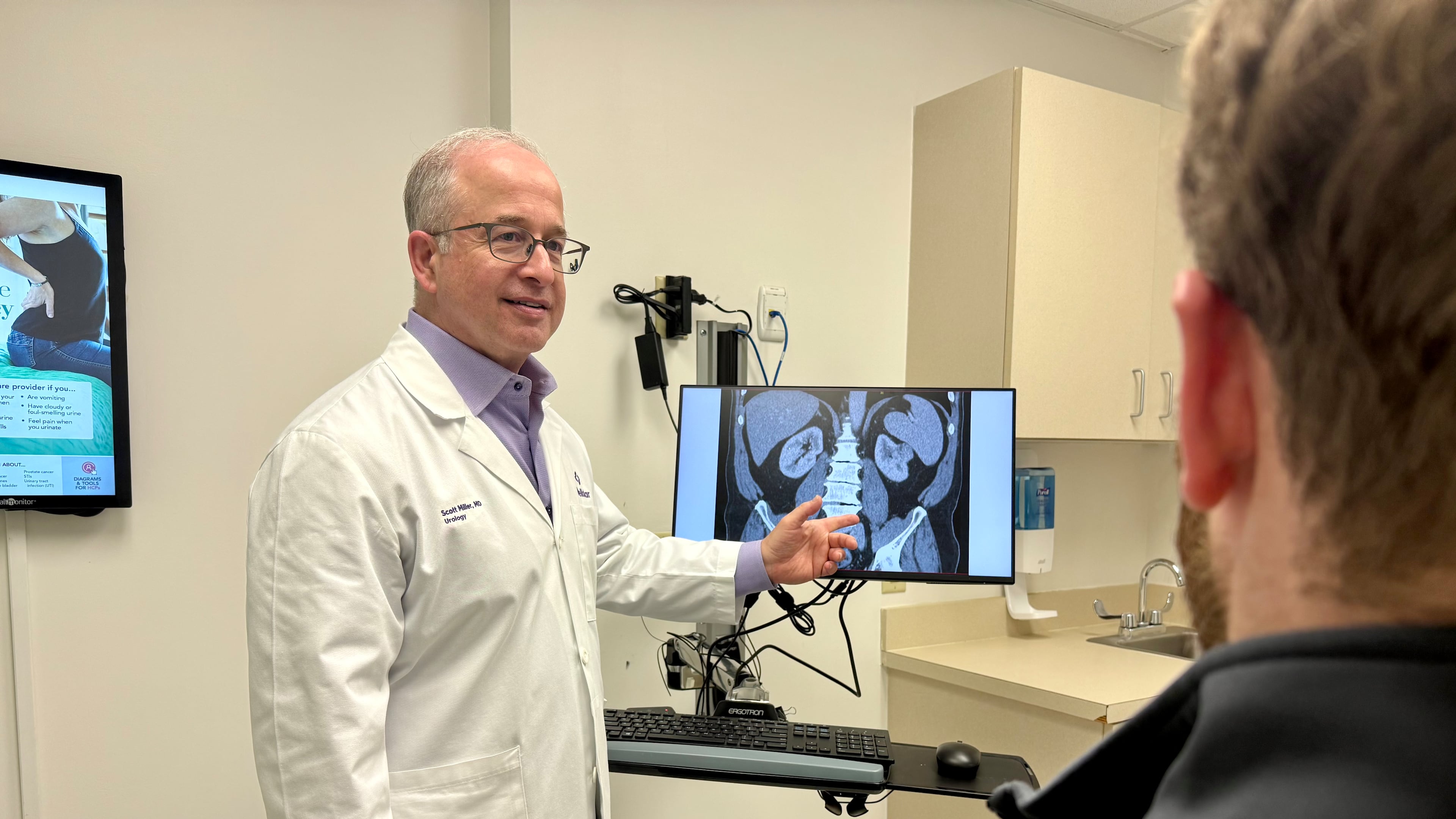 Dr. Scott Miller, a longtime urologist with Wellstar Health System, talks with a patient about men's health. (Courtesy of Wellstar Health System)