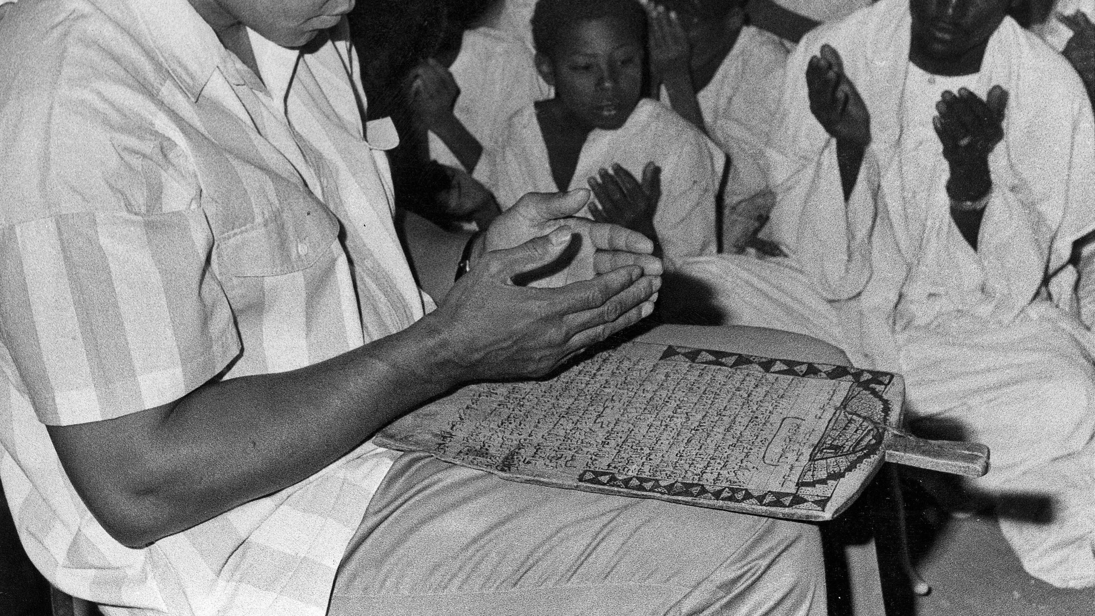 In this 1988 file photo, former world heavyweight boxing champ Muhammad Ali prays with a class of Muslim boys at Dafaalah el Sa'em Mosque in Khartoum, Sudan. As one of the most famous Muslims in the world, he traveled widely as a goodwill ambassador, spreading the message of Islam as a religion of peace. AP/Abder Raouf