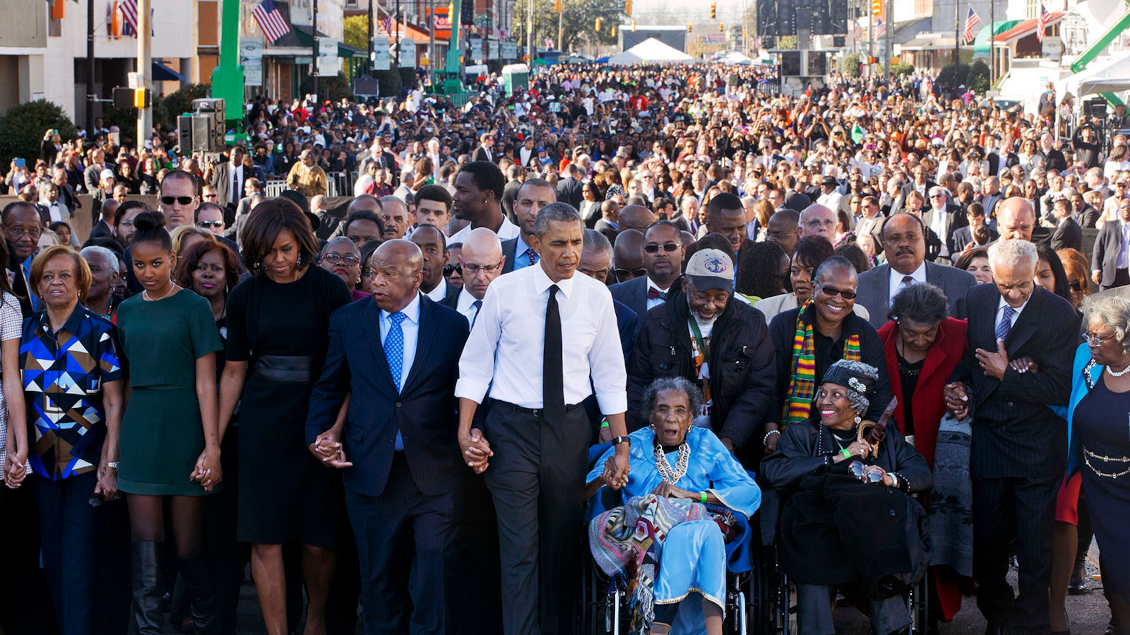 John Lewis returned every year to Selma to walk across the Edmund Pettus Bridge. In 2015, he commemorated the 50th anniversary of Bloody Sunday by joining hands with President Barack Obama and his family and leading a march. Other survivors of Bloody Sunday helped lead the procession. The event included a rare joint appearance by Obama and President George W. Bush, who also attended. (Jacquelyn Martin/AP)