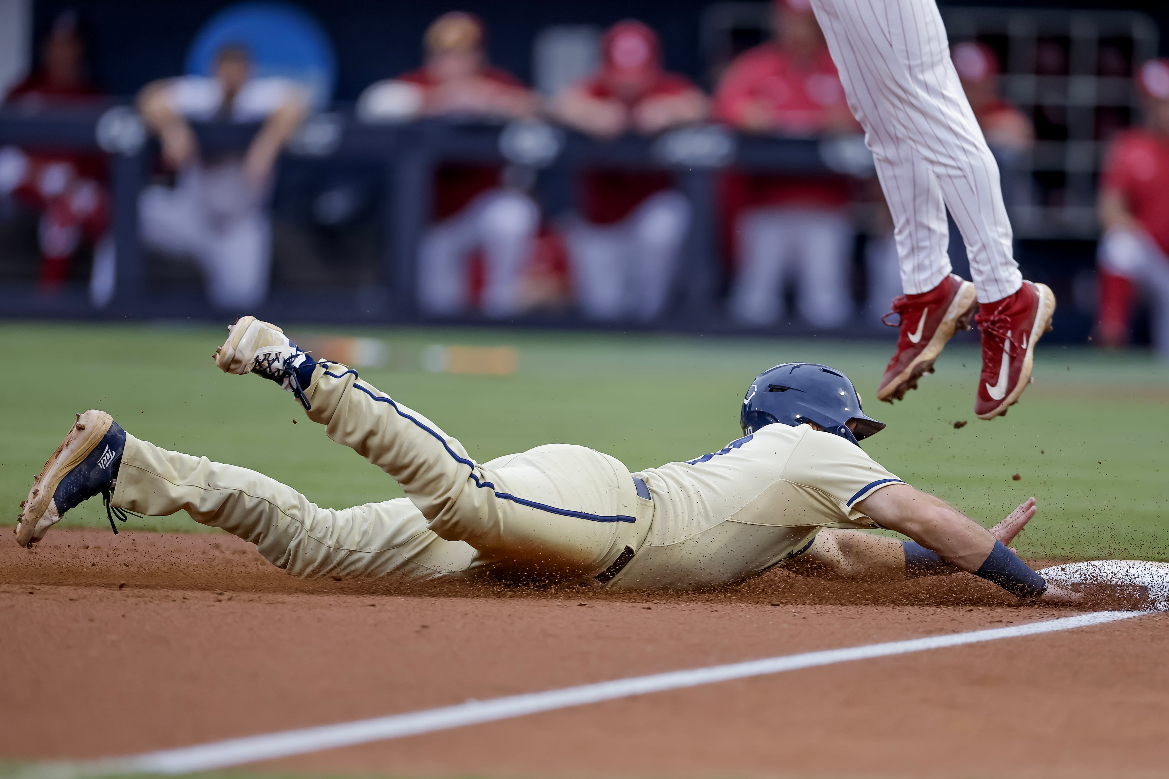 Georgia Tech's Kent Schmidt (left) advances to third base against Oklahoma third baseman Camden Johnson during the third inning of the Atlanta Regional game at Russ Chandler Stadium, Sunday, May 31, 2026, in Atlanta. (Erik S. Lesser for the AJC)