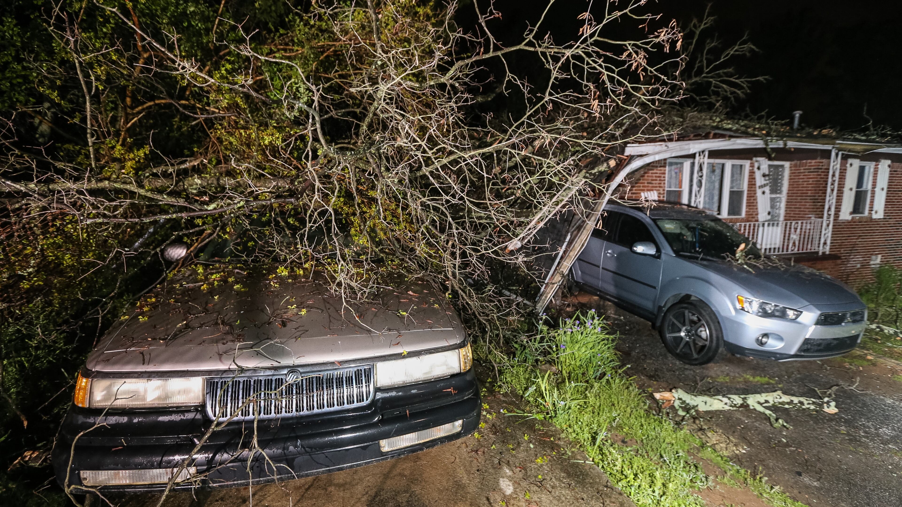 Wind and rain left one home’s carport damaged Tues., April 12, 2016, when a tree fell on it in northwest Atlanta. JOHN SPINK / JSPINK@AJC.COM