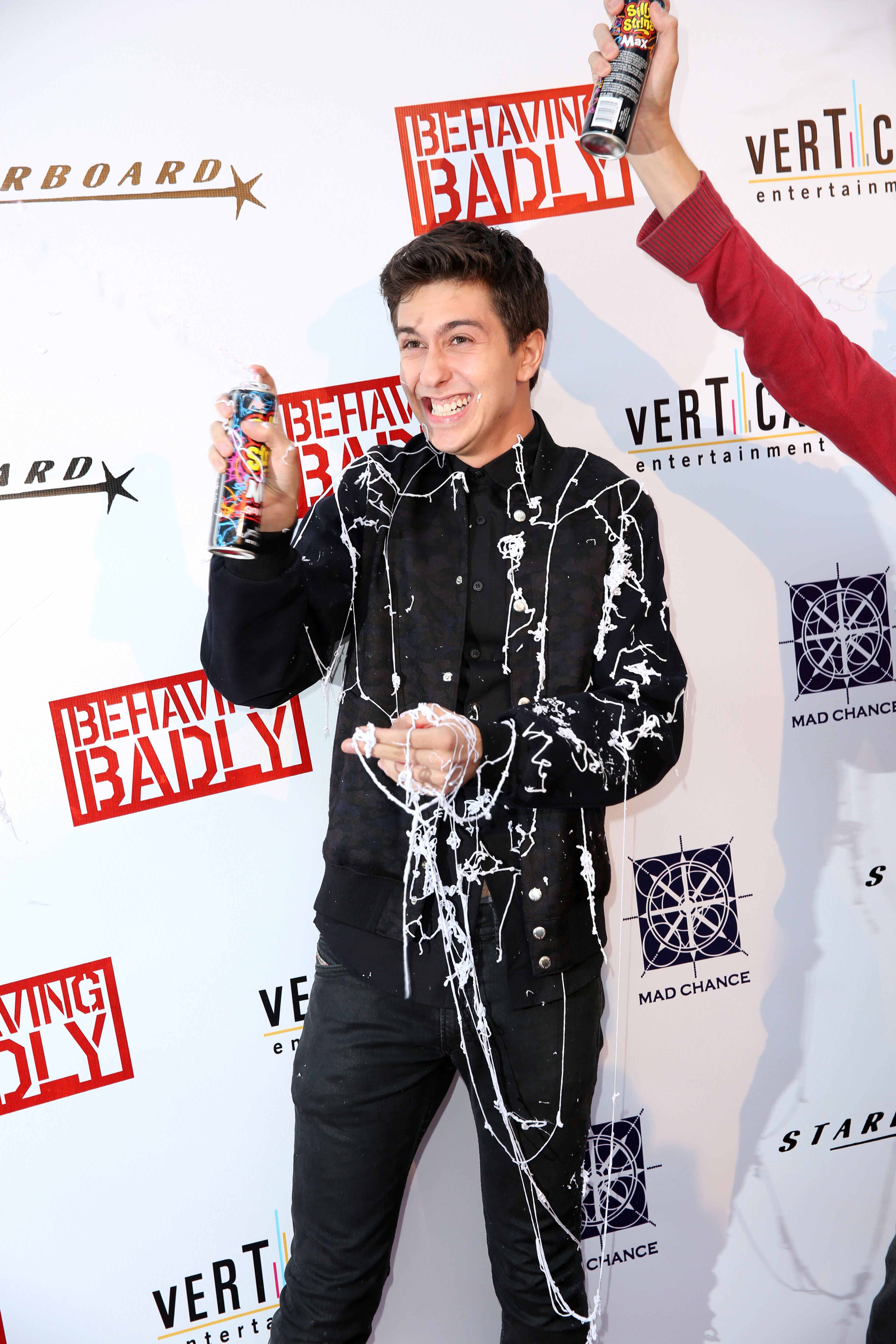 Nat Wolff sprays silly string on the red carpet for a special screening of "Behaving Badly" on Tuesday, July 29, 2014 in Los Angeles. (Photo by Matt Sayles/Invision/AP)