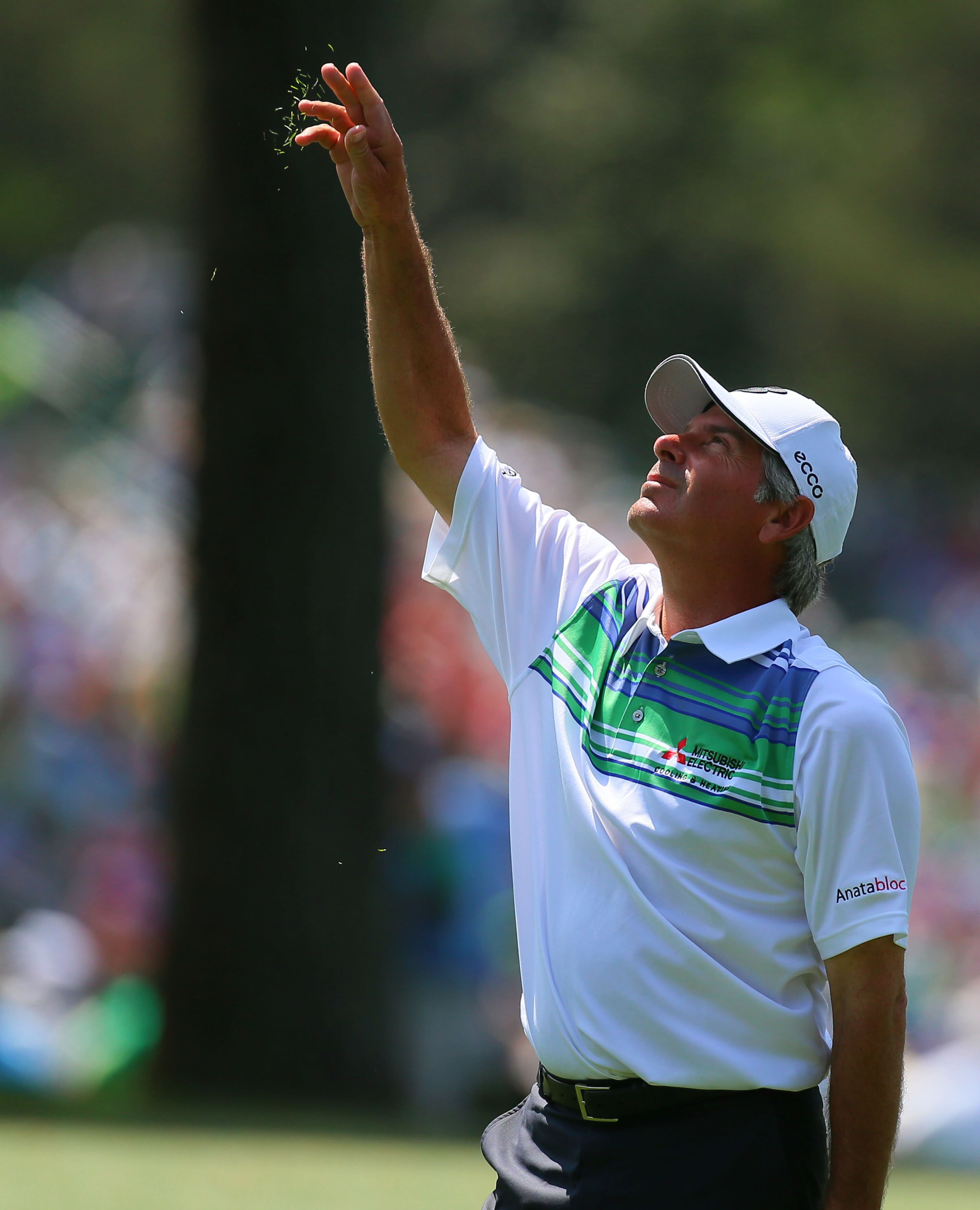 Fred Couples tests the wind on the #17 fairway before taking his second shot during the second round in the Masters Tournament on Friday April 12 2013. CURTIS COMPTON / CCOMPTON@AJC.COM