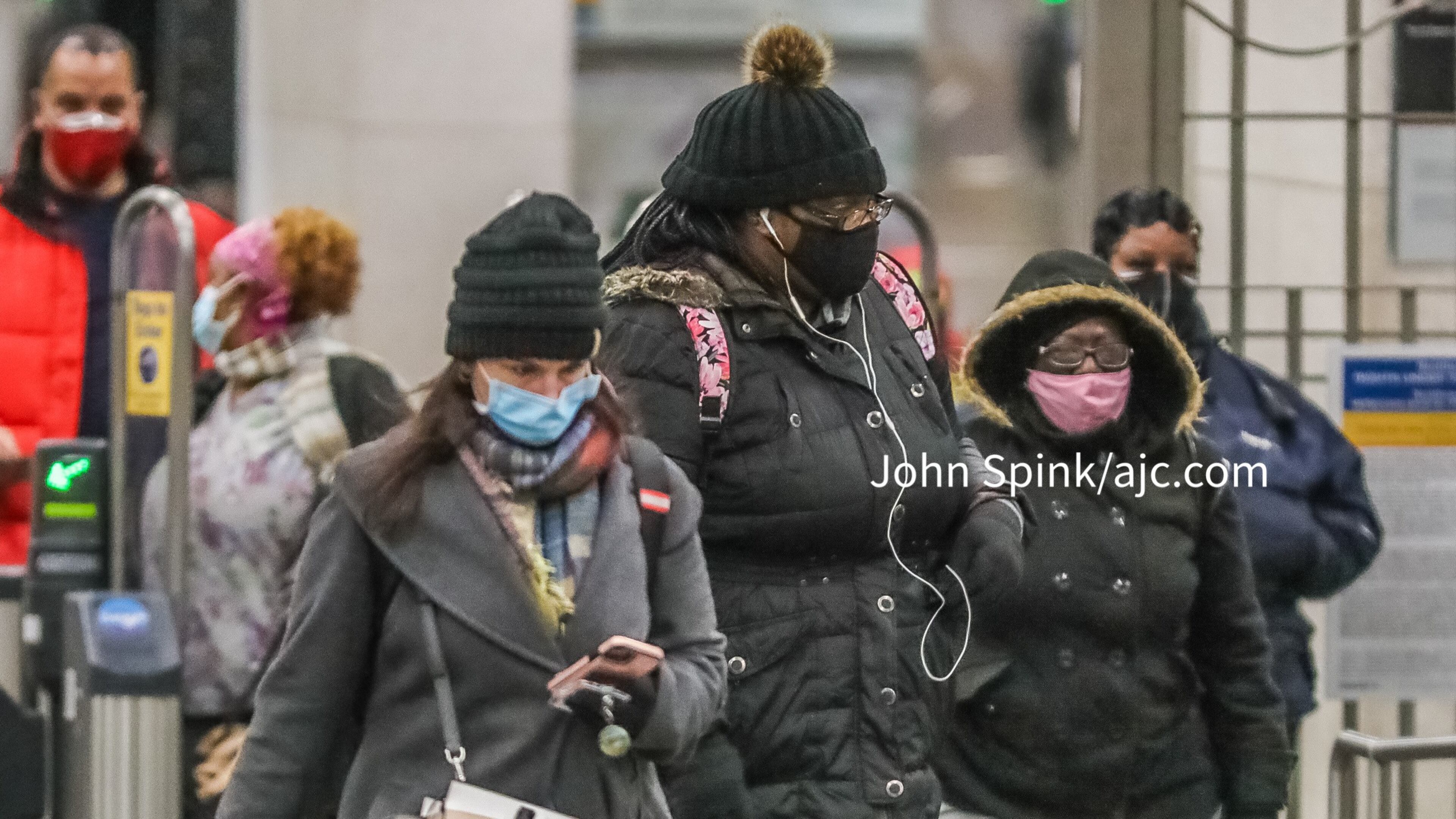 Commuters bundle up against the cold air coming out of Five Points MARTA station in downtown Atlanta.