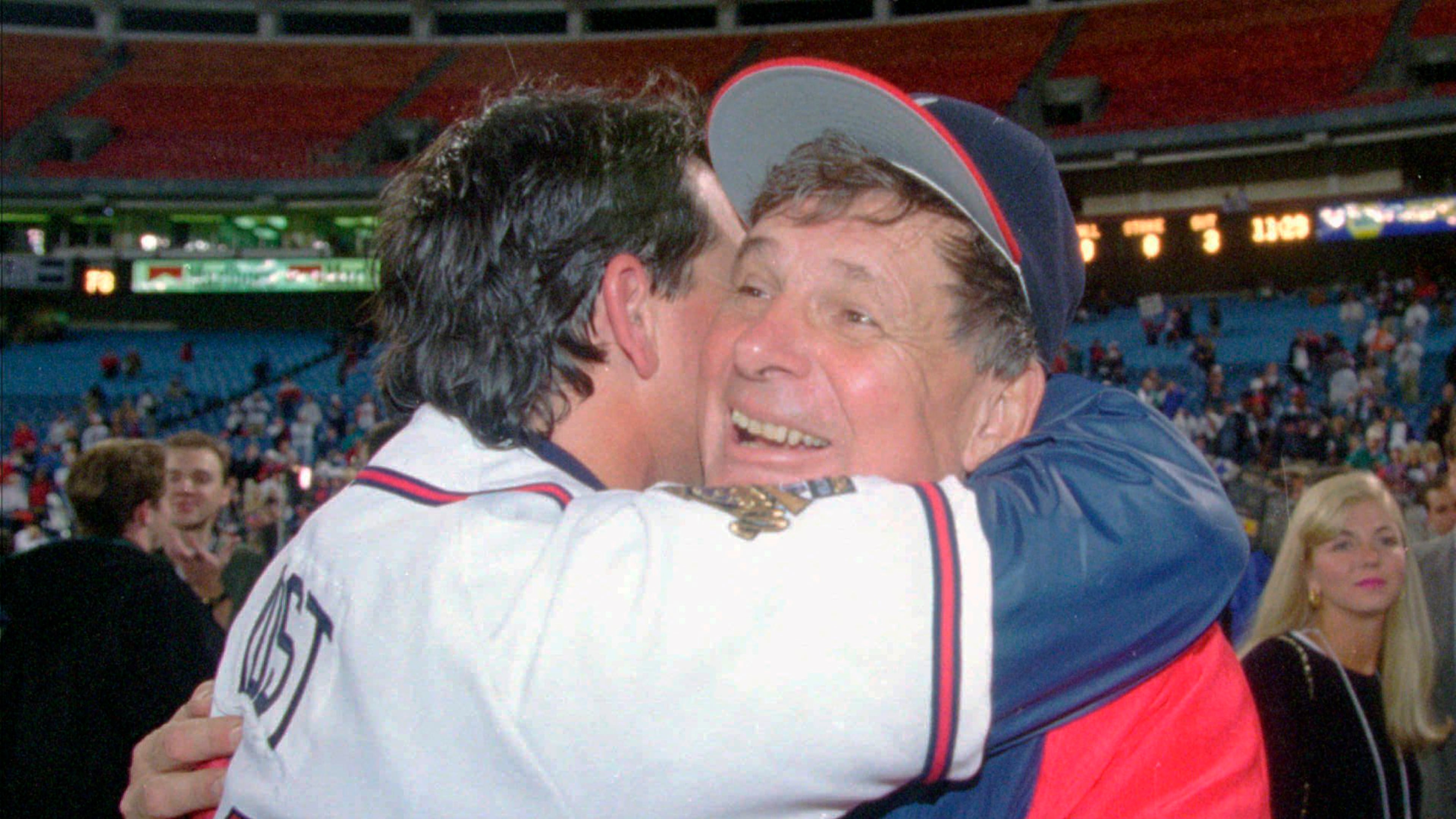 Manger Bobby Cox, right, hugs bullpen coach Ned Yost after the Braves locked up the World Series against Cleveland 25 years ago. (AP Photo/John Bazemore, File)