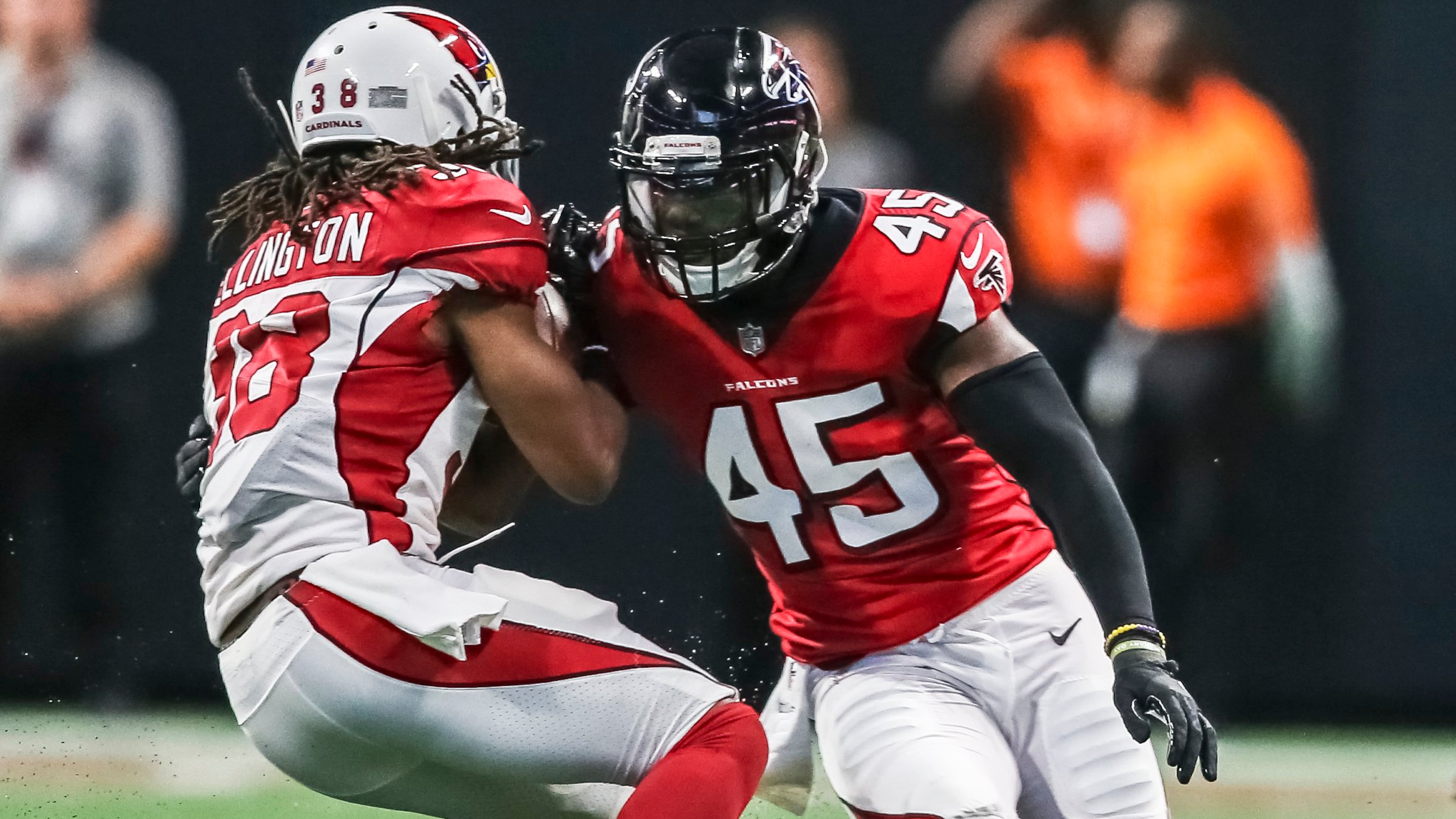 Falcons middle linebacker Deion Jones (45) (right) comes up on Arizona Cardinals running back Andre Ellington. JOHN SPINK/JSPINK@AJC.COM