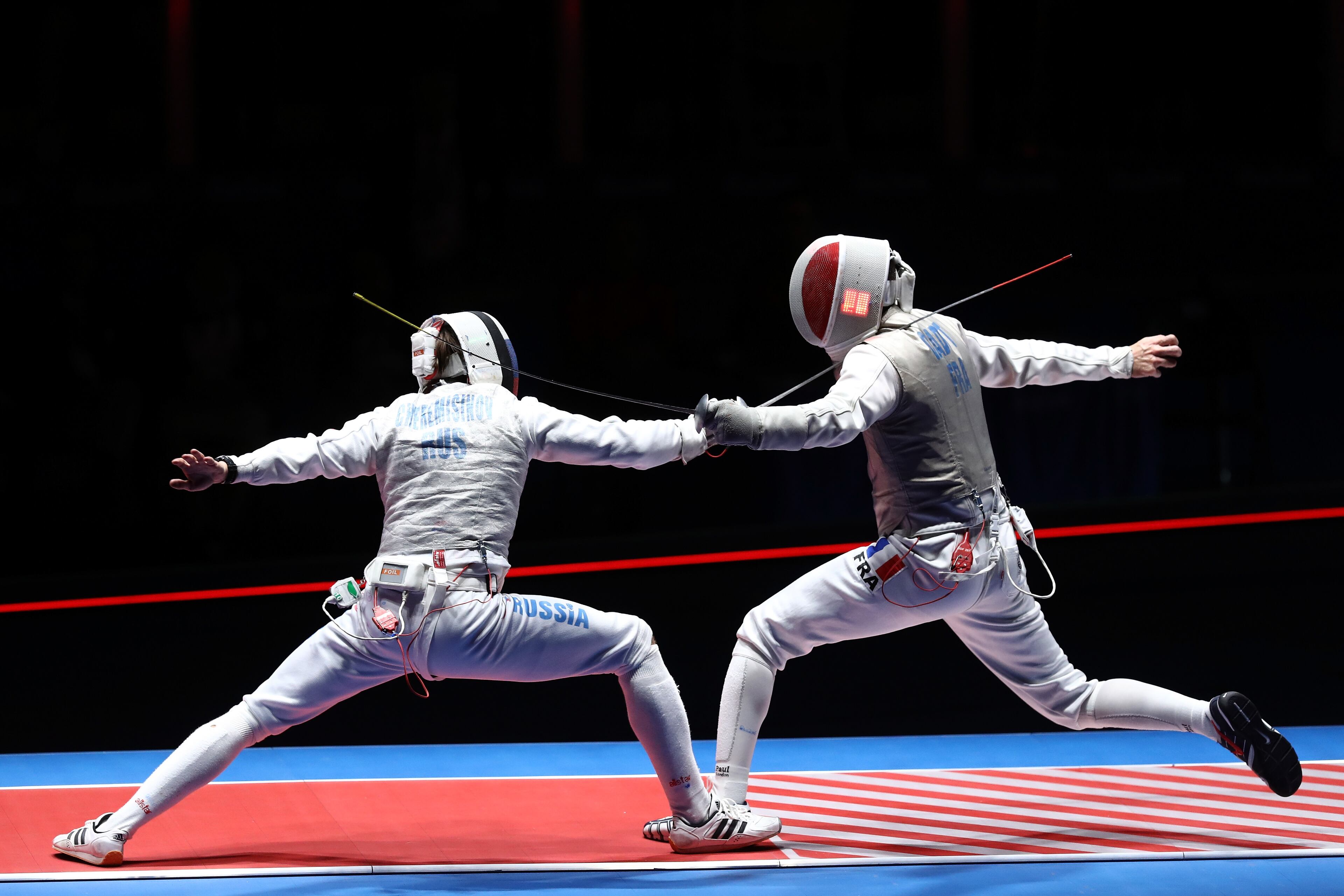 RIO DE JANEIRO, BRAZIL - AUGUST 12: Jeremy Cadot of France competes against Alexey Cheremisinov of Russia during the Men's Foil Team Gold Medal Match bout on Day 7 of the Rio 2016 Olympic Games at Carioca Arena 3 on August 12, 2016 in Rio de Janeiro, Brazil. (Photo by Ezra Shaw/Getty Images)