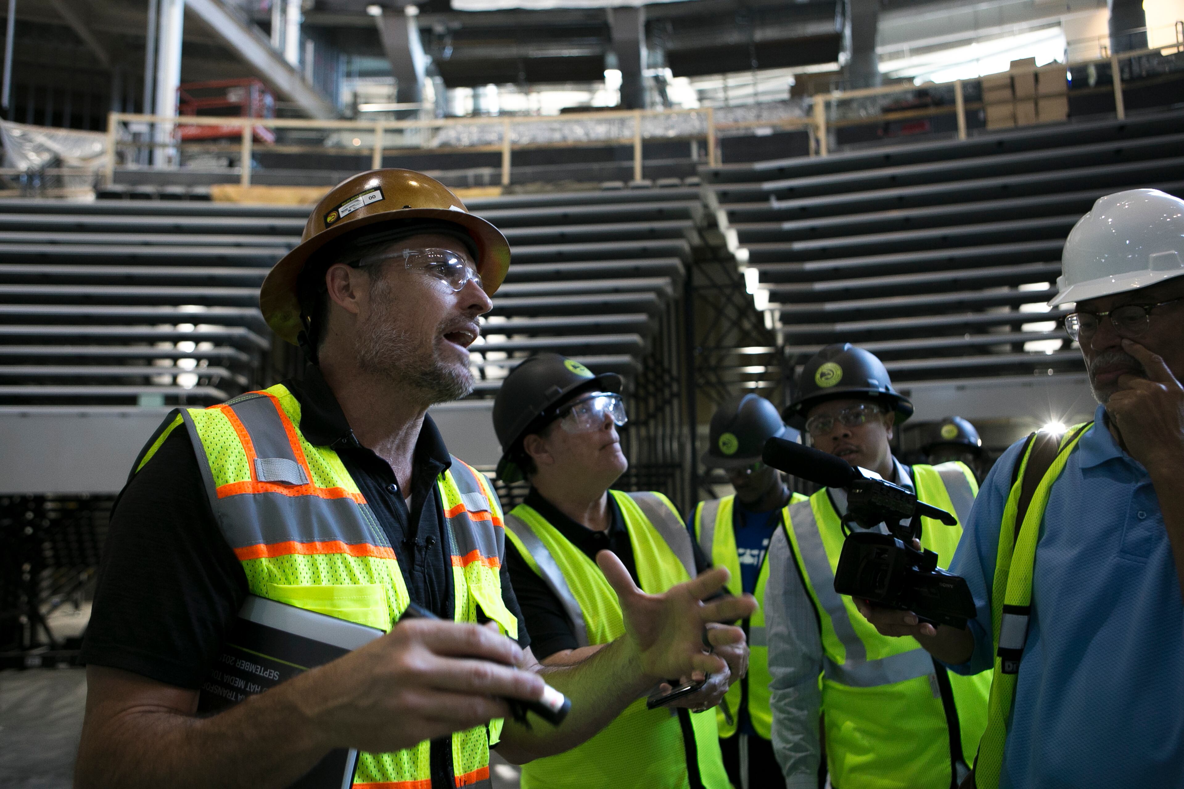 Brett Stefansson, Atlanta Hawks executive vice president and general manager of State Farm Arena, speaks to members of the media on the main court during a guided media tour through the in-progress renovations at the State Farm Arena in Atlanta, Ga., on Thurs., Sept. 20, 2018. The renovations, which total $192.5 million, are on track to be completed by the arena's scheduled open house on October 20. The current rate of progress is about $1 million of work per day, according to Stefansson. (CASEY SYKES, CASEYLANESYKES@GMAIL.COM)