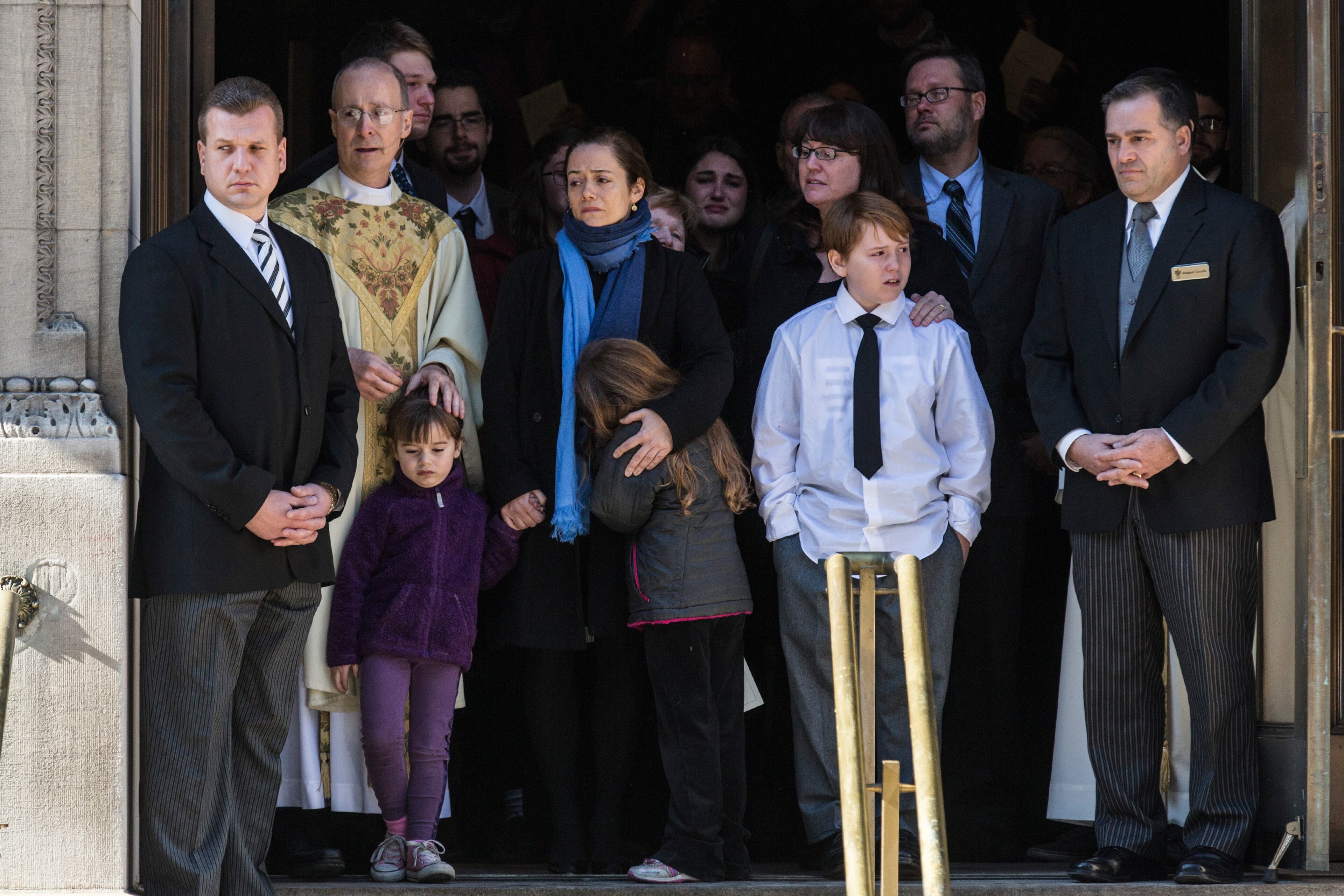 NEW YORK, NY - FEBRUARY 07: Mimi O'Donnell (C), partner of actor Philip Seymour Hoffman, along with their children (L-R), Willa Hoffman, Tallulah Hoffman and Cooper Hoffman, watch as the casket carrying Hoffman, who died of an alleged drug overdose on February 1, 2014, leaves Hoffman's funeral service at St. Ignatius Of Loyola on February 7, 2014 in New York City. Hoffman was allegedly found dead in his bathroom with a needle in his arm. (Photo by Andrew Burton/Getty Images)