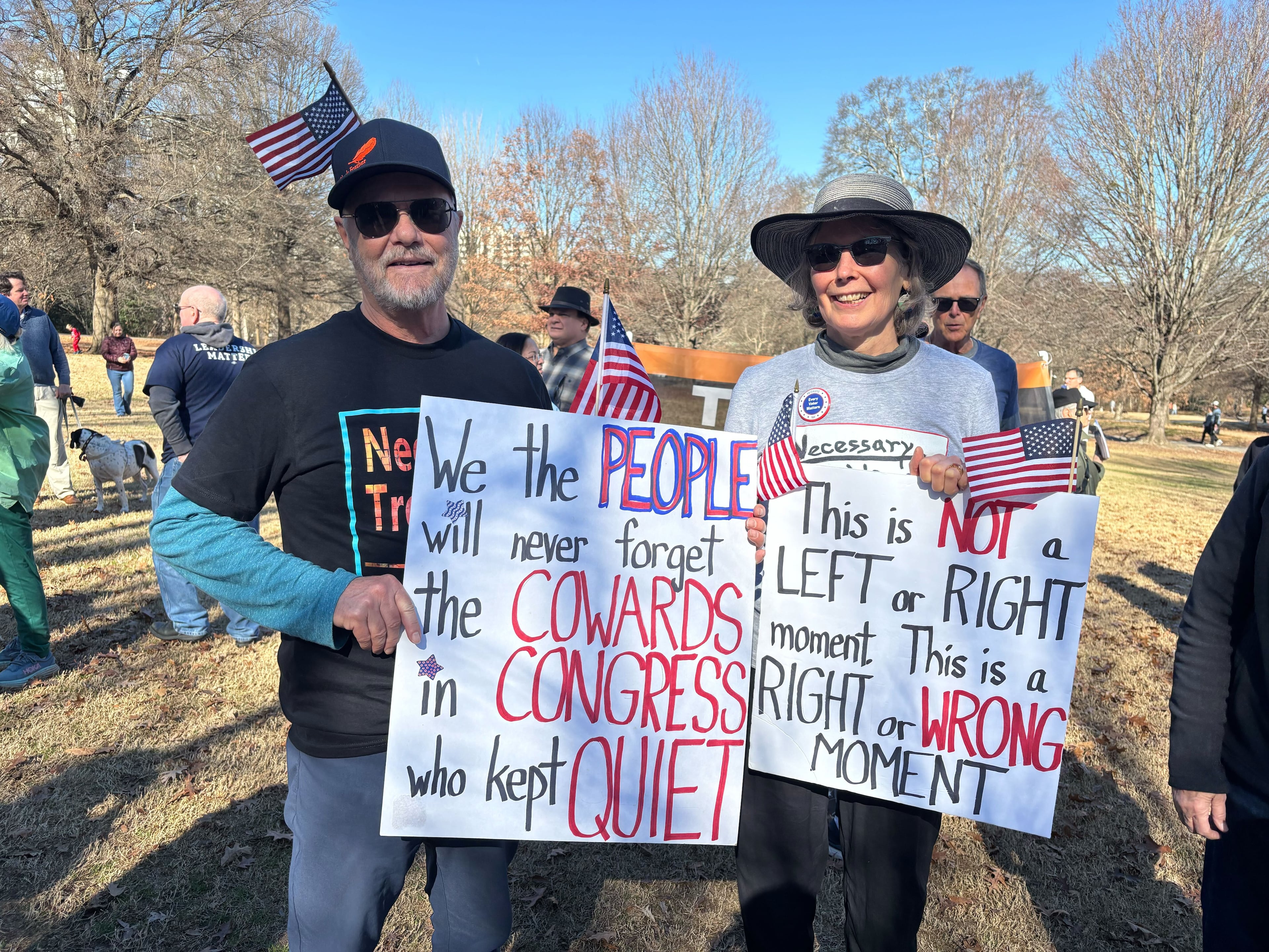 Michael Beach (left) attends a rally at Piedmont Park Sunday that was organized by people who are against the recent U.S. operation in Venezuela.