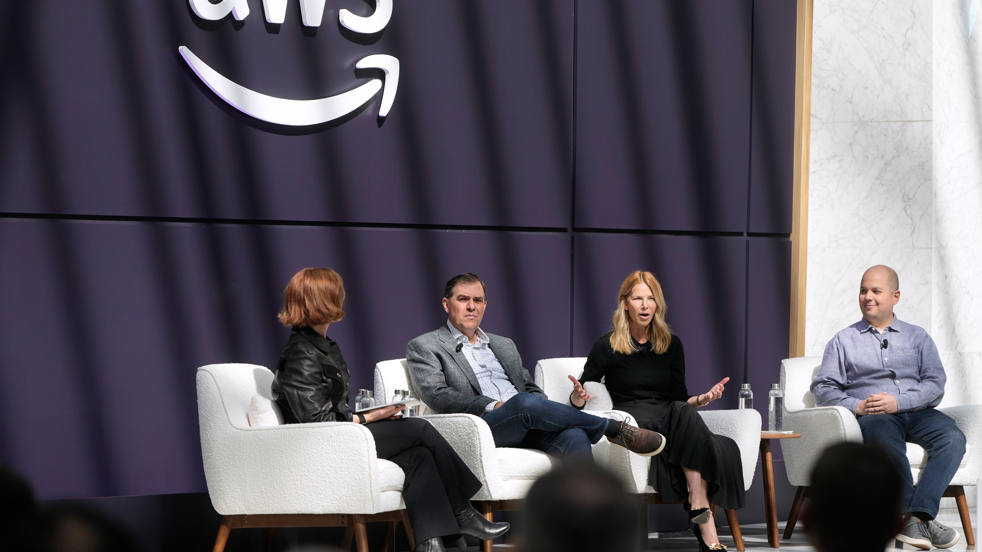 Denise Dresser, chief revenue officer of OpenAI, second right, speaks on stage with Julia White, vice president & chief marketing officer, AWS, from left, Matt Garman, CEO of AWS, and Anthony Liguori, vice president and distinguished engineer, AWS, at a What's Next with AWS event, Tuesday, April 28, 2026, in San Francisco. (AP Photo/Jeff Chiu)