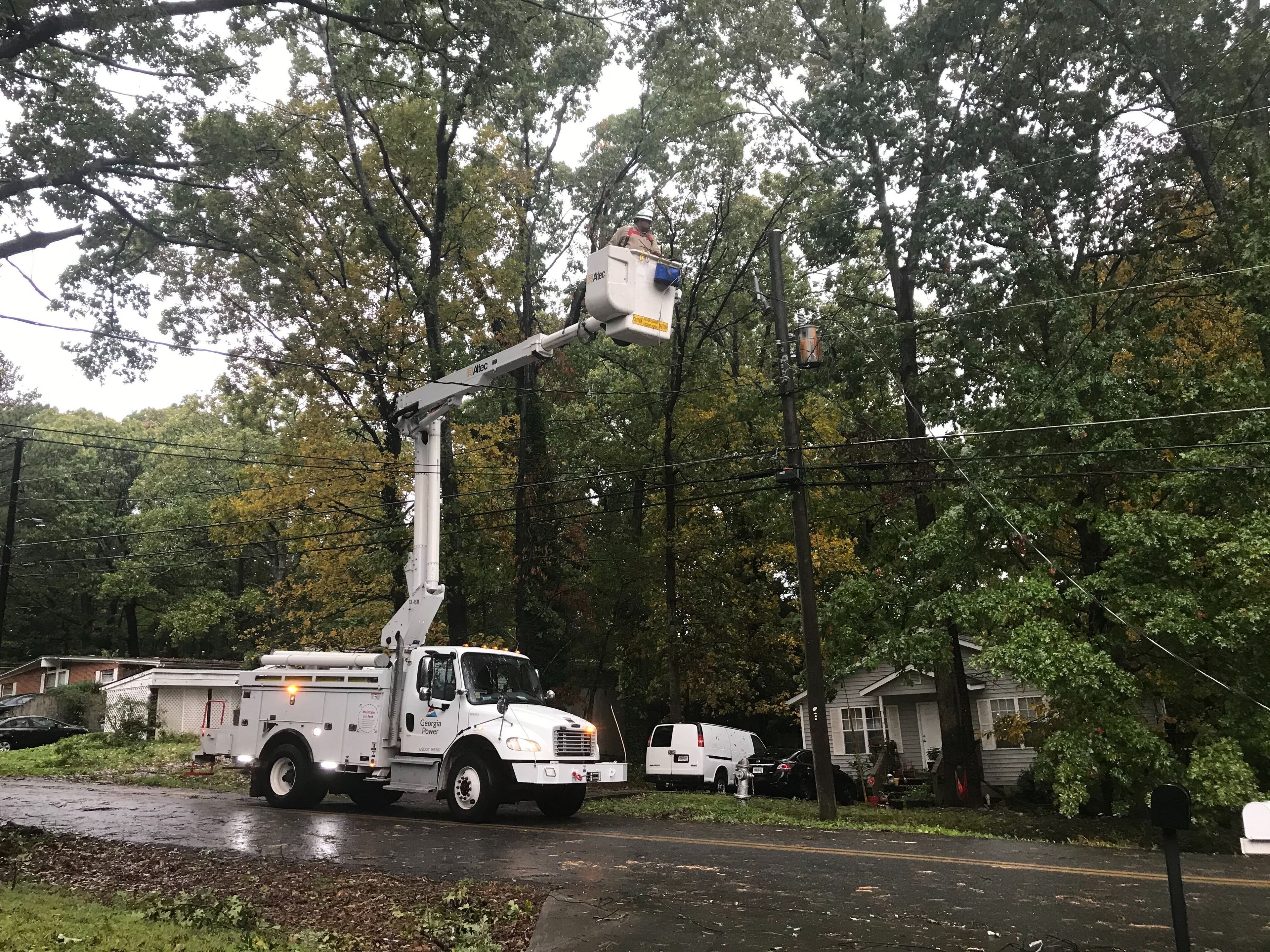 A Georgia Power crew making repairs about 9 a.m. Thursday on Lake Drive in Gwinnett County. (Photo by Vanessa McCray / AJC)