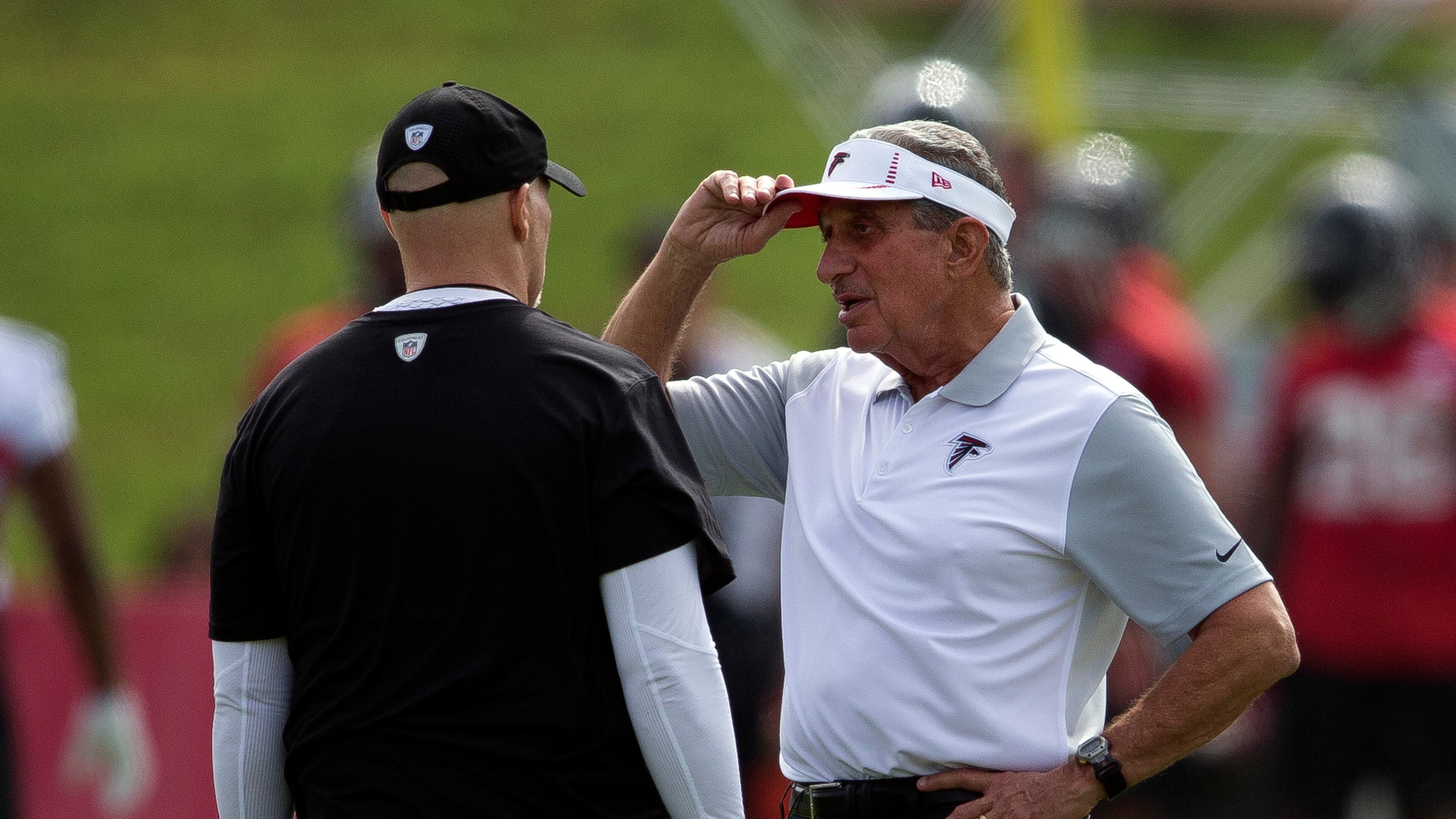 Falcons owner Arthur Blank talks with coach Dan Quinn during training camp.