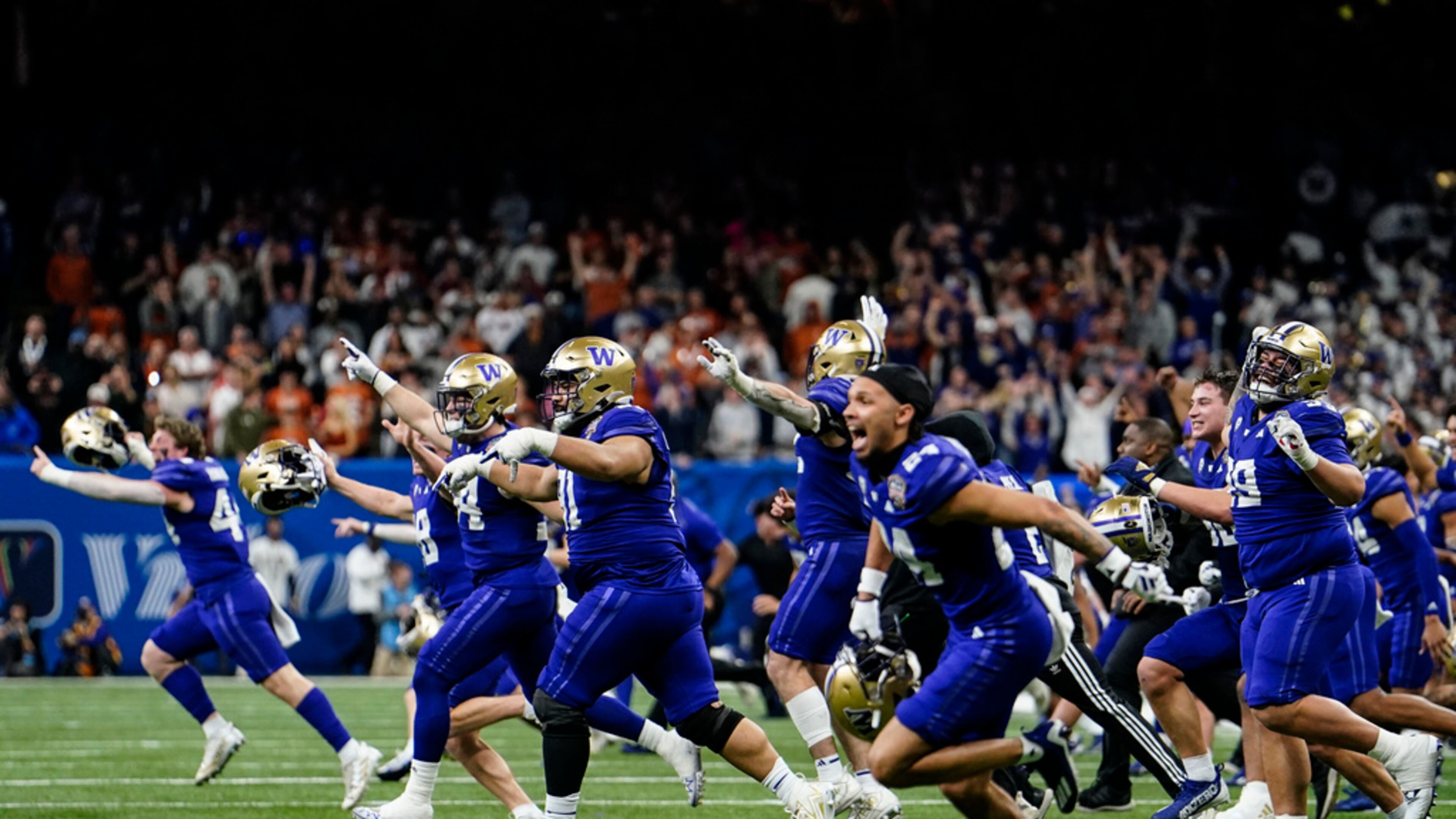 Washington players celebrate victory against Texas after the Sugar Bowl CFP NCAA semifinal college football game between Washington and Texas, Monday, Jan. 1, 2024, in New Orleans. Washington won 37-31. (AP Photo/Jacob Kupferman)