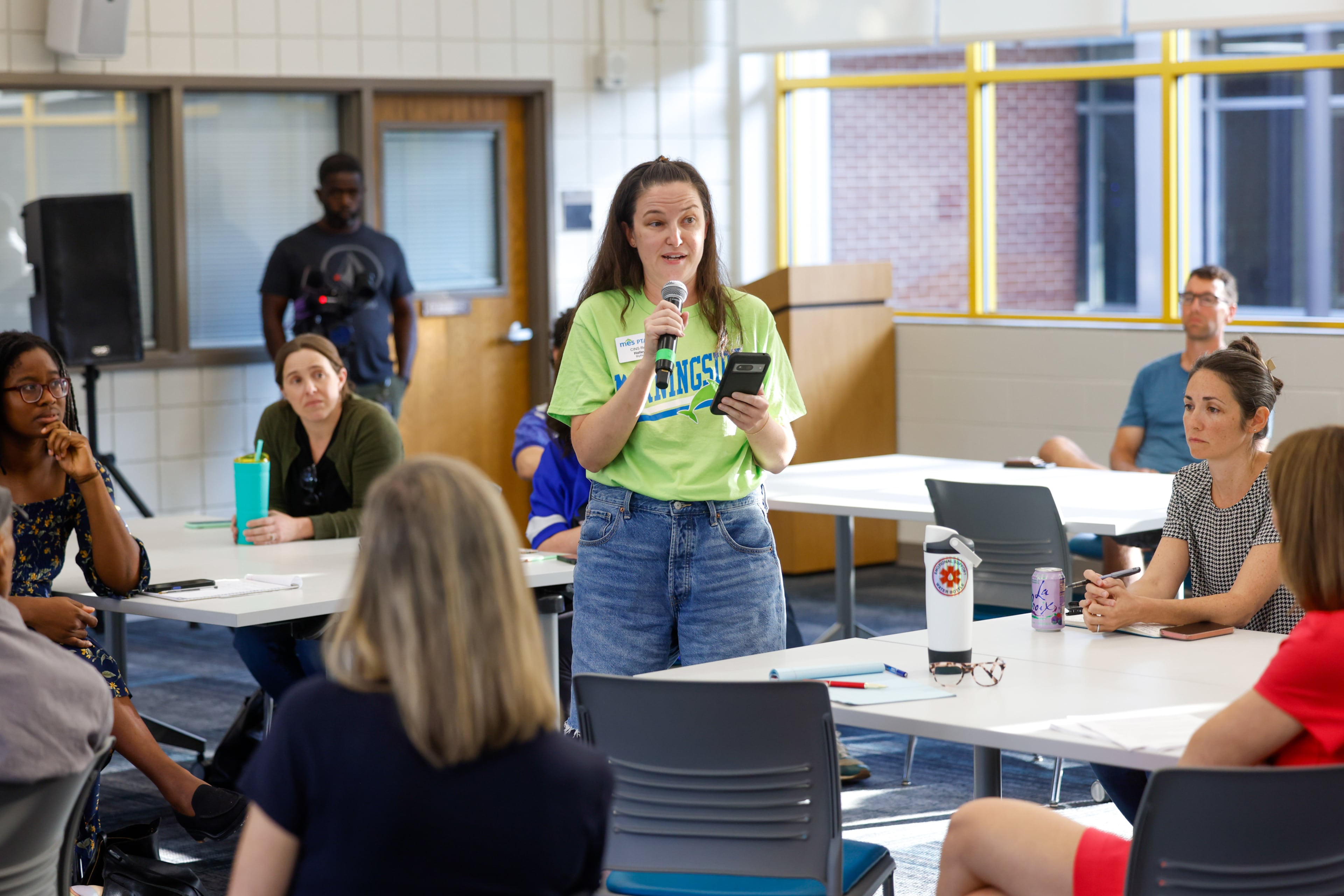 Morningside Elementary School parent Halley Blythe tells the June town hall she is in favor of new limits on classroom screen time. (Arvin Temkar/AJC)