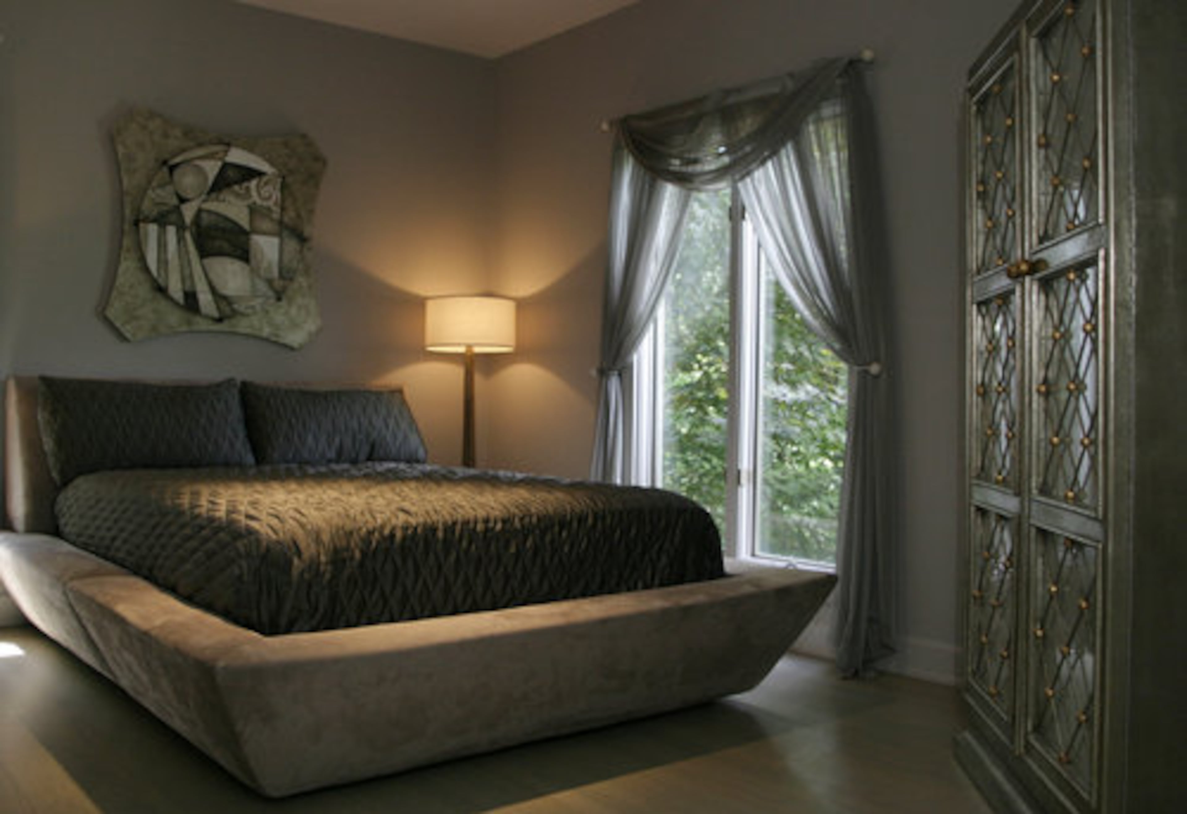 This guest suite has a cool, cozy bed that might encourage a guest to stay too long. All of the art in their home is sold at Huff. "(Checo) Diego is my favorite piece in the guest room," Julie Huff said of the artwork hanging over the bed.