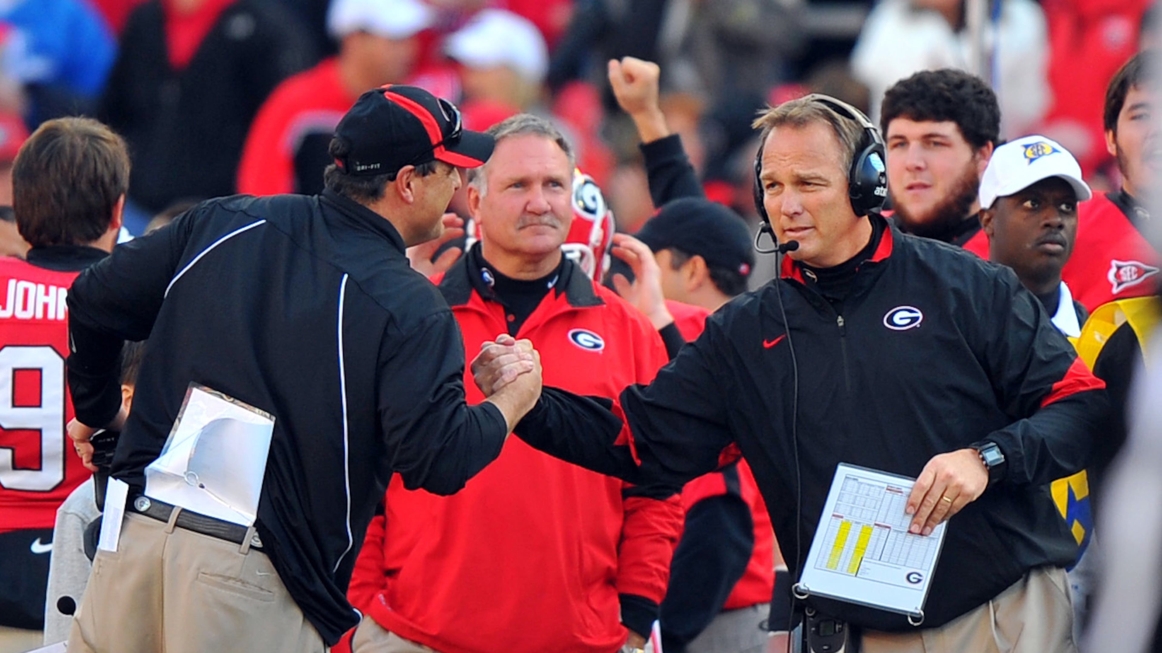 Georgia head coach Mark Richt, right and defensive coordinator Todd Grantham celebrate during the final seconds against Kentucky at Sanford Stadium Saturday November 19, 2011.