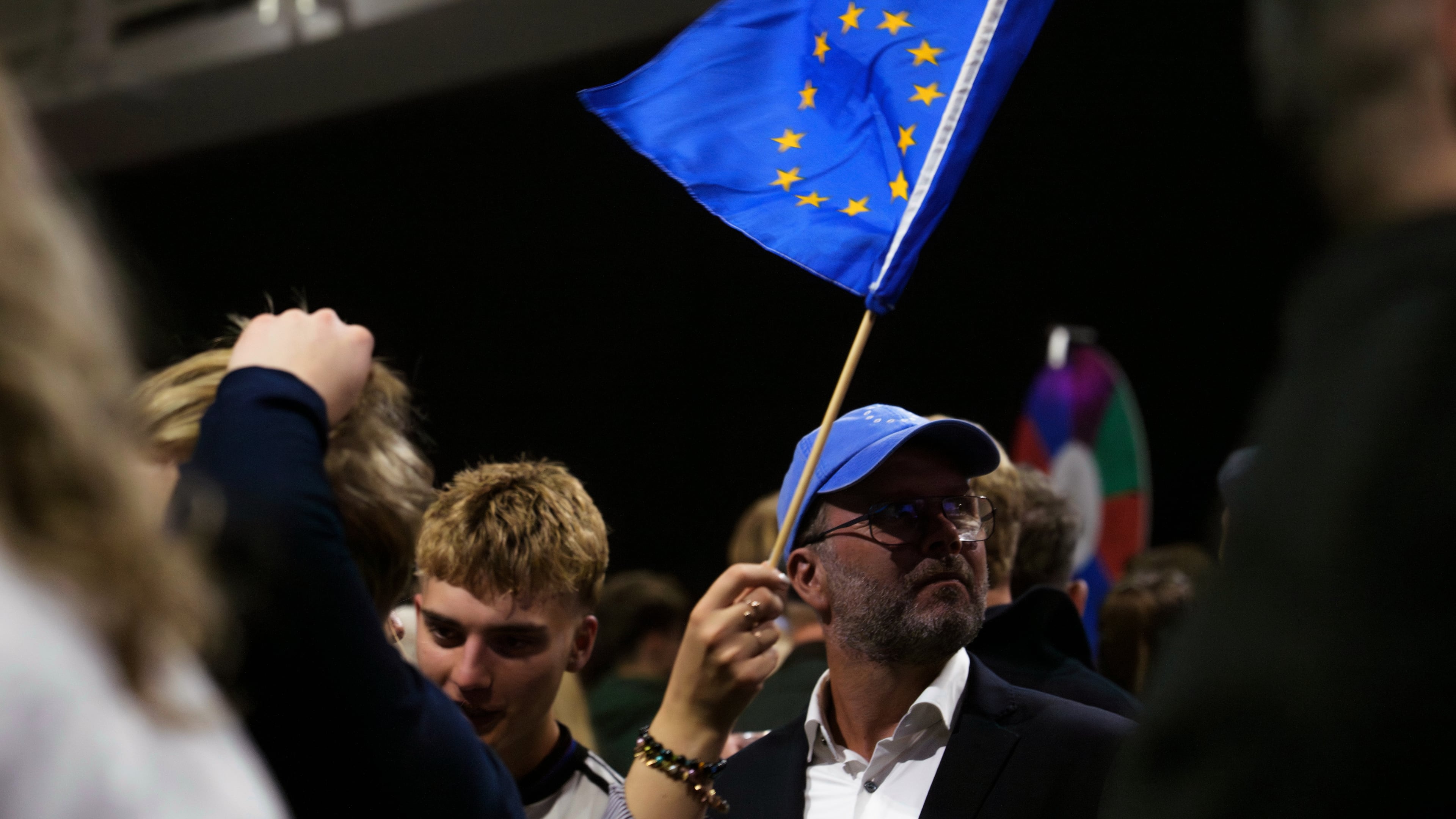 A supporter waves a European Union flag during an election-night gathering for the yes in Reykjavik, Iceland, Sunday, Aug. 30, 2026. (AP Photo/Marco Di Marco)