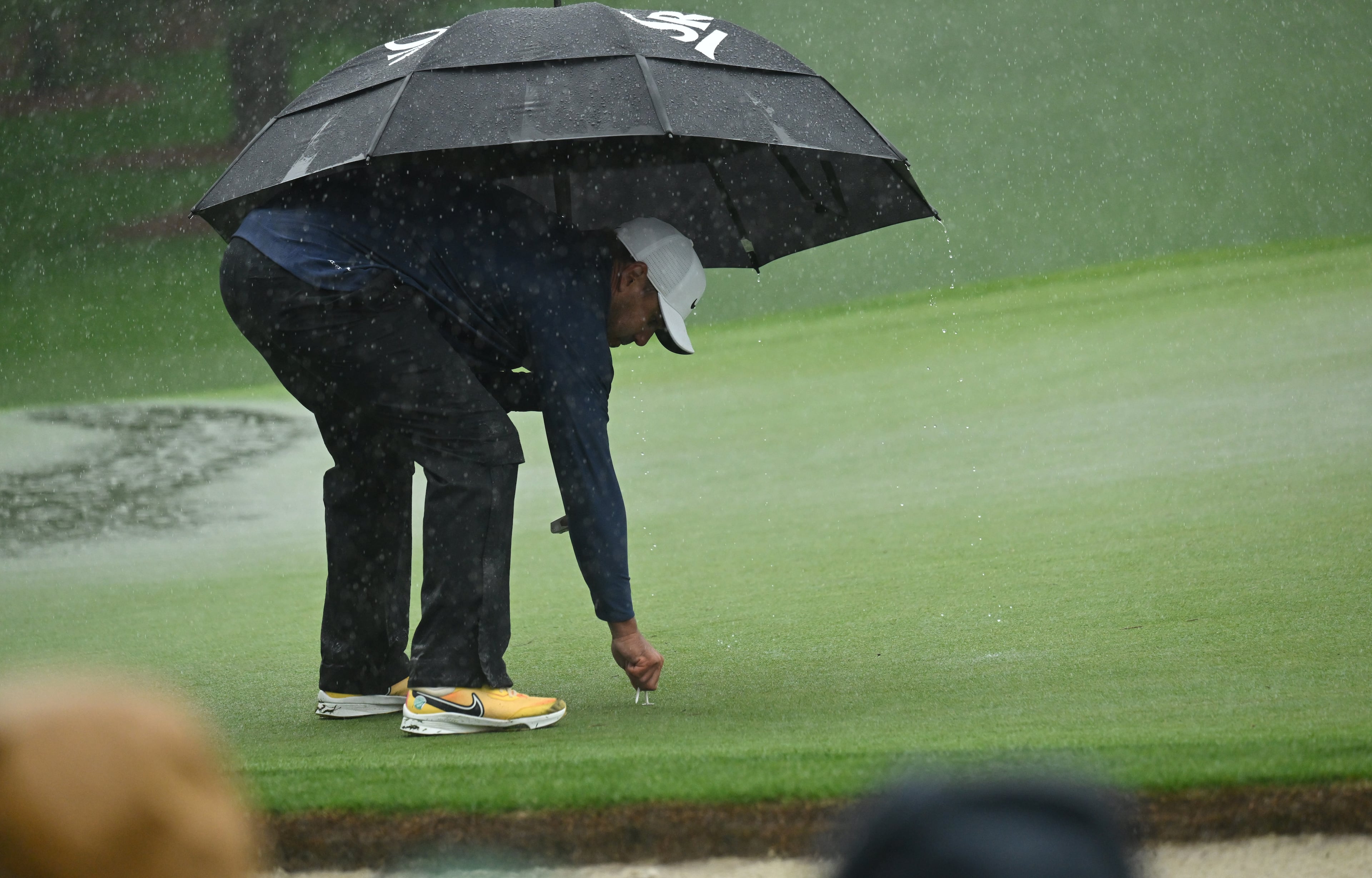 Brooks Koepka makes pin placement on seventh green as play is suspended during third round of the 2023 Masters Tournament at Augusta National Golf Club, Saturday, April 8, 2023, in Augusta, Ga. (Hyosub Shin / Hyosub.Shin@ajc.com)