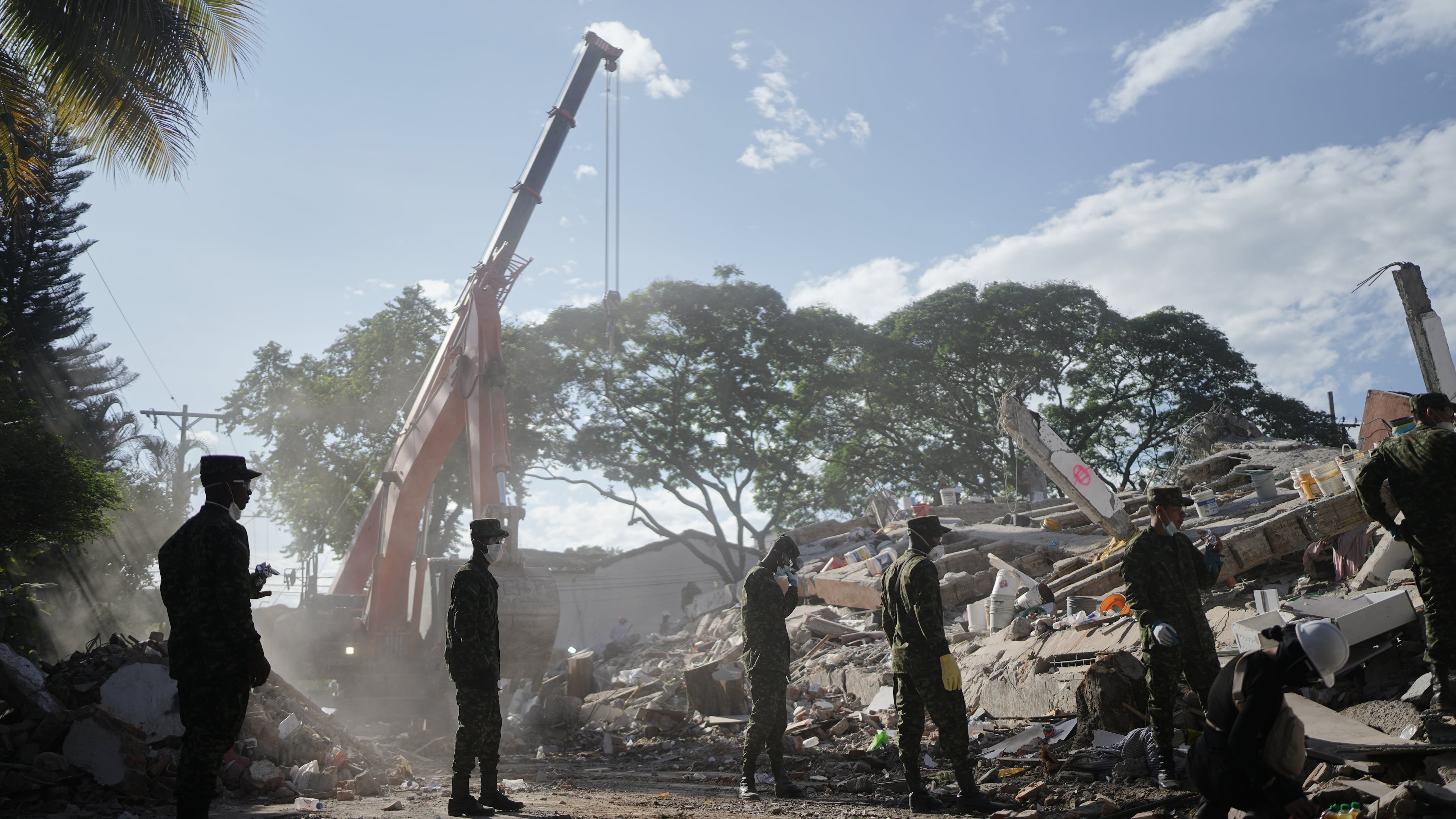 Soldiers clear debris three days after an earthquake struck Cali, Colombia, Thursday, Aug. 13, 2026. (AP Photo/Ivan Valencia)