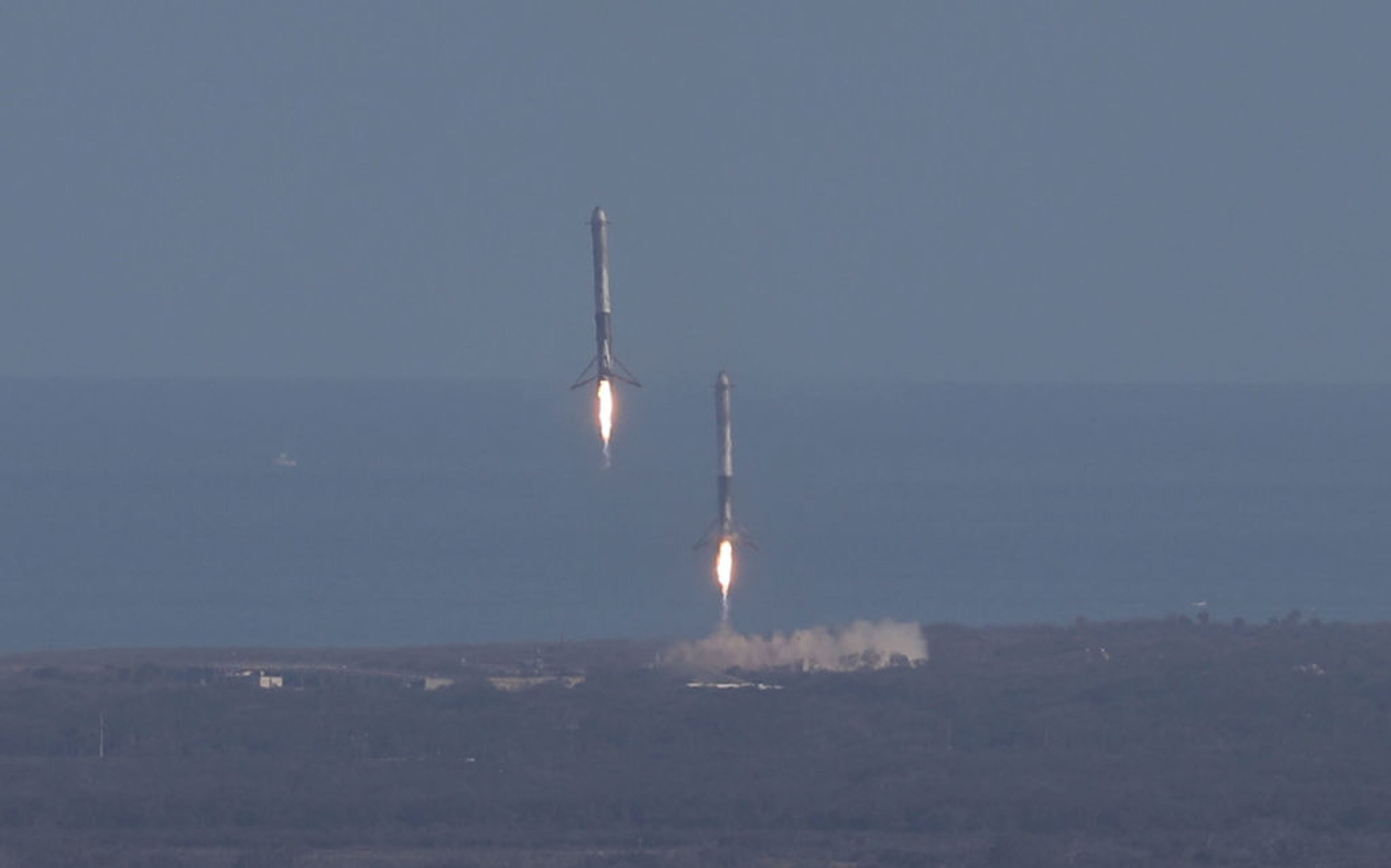 CAPE CANAVERAL, FL - FEBRUARY 06: Two of the boosters land at Cape Canaveral Air Force Station after the launch of SpaceX Falcon Heavy rocket from launch pad 39A at Kennedy Space Center on February 6, 2018 in Cape Canaveral, Florida. The rocket is the most powerful rocket in the world and is carrying a Tesla Roadster into orbit. (Photo by Joe Raedle/Getty Images)