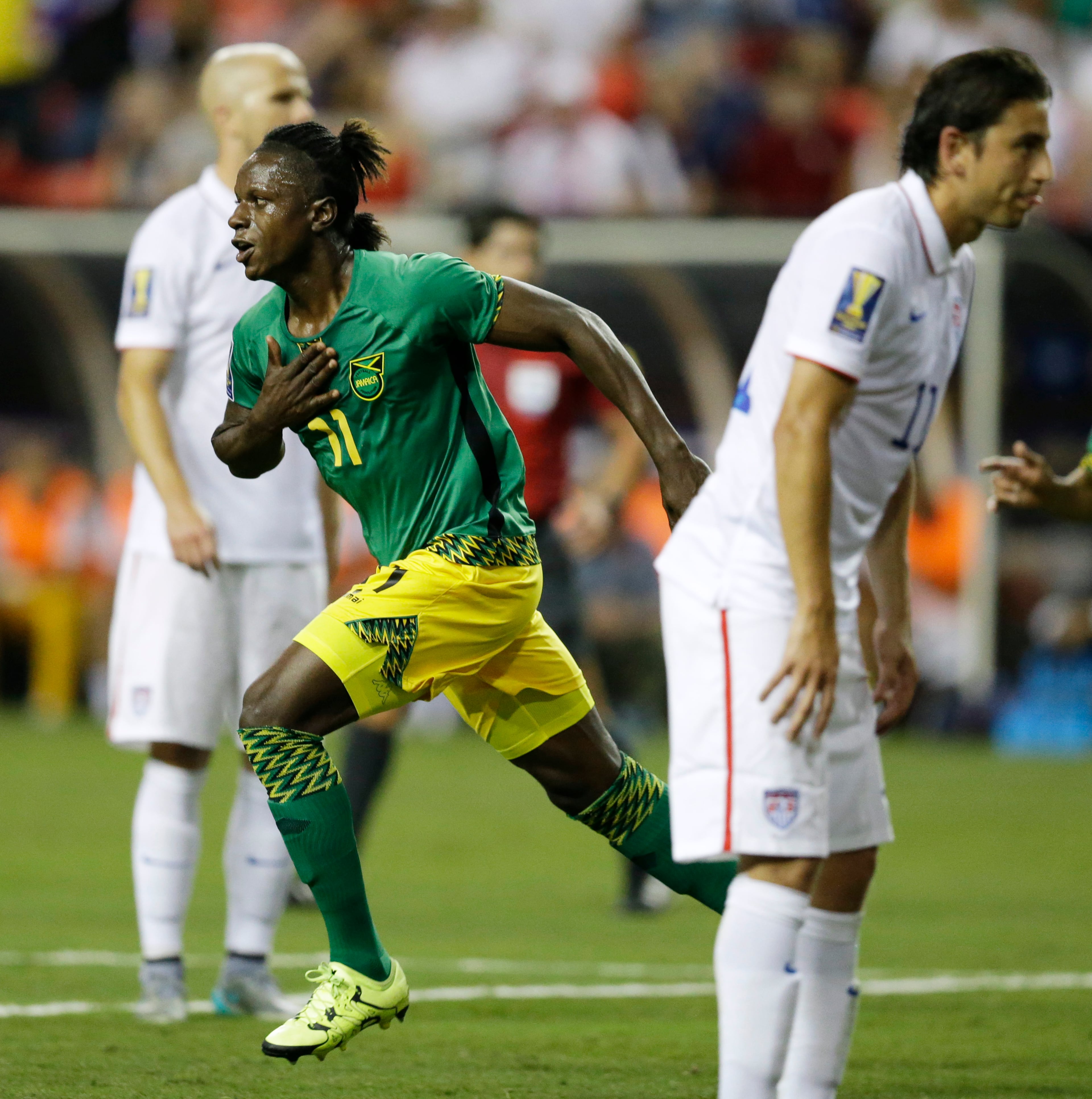 Jamaica's Darren Mattocks, left, celebrates after scoring a goal during the first half of a CONCACAF Gold Cup semifinal playoff soccer game against the United States Wednesday, July 22, 2015, in Atlanta. (AP Photo/David Goldman)