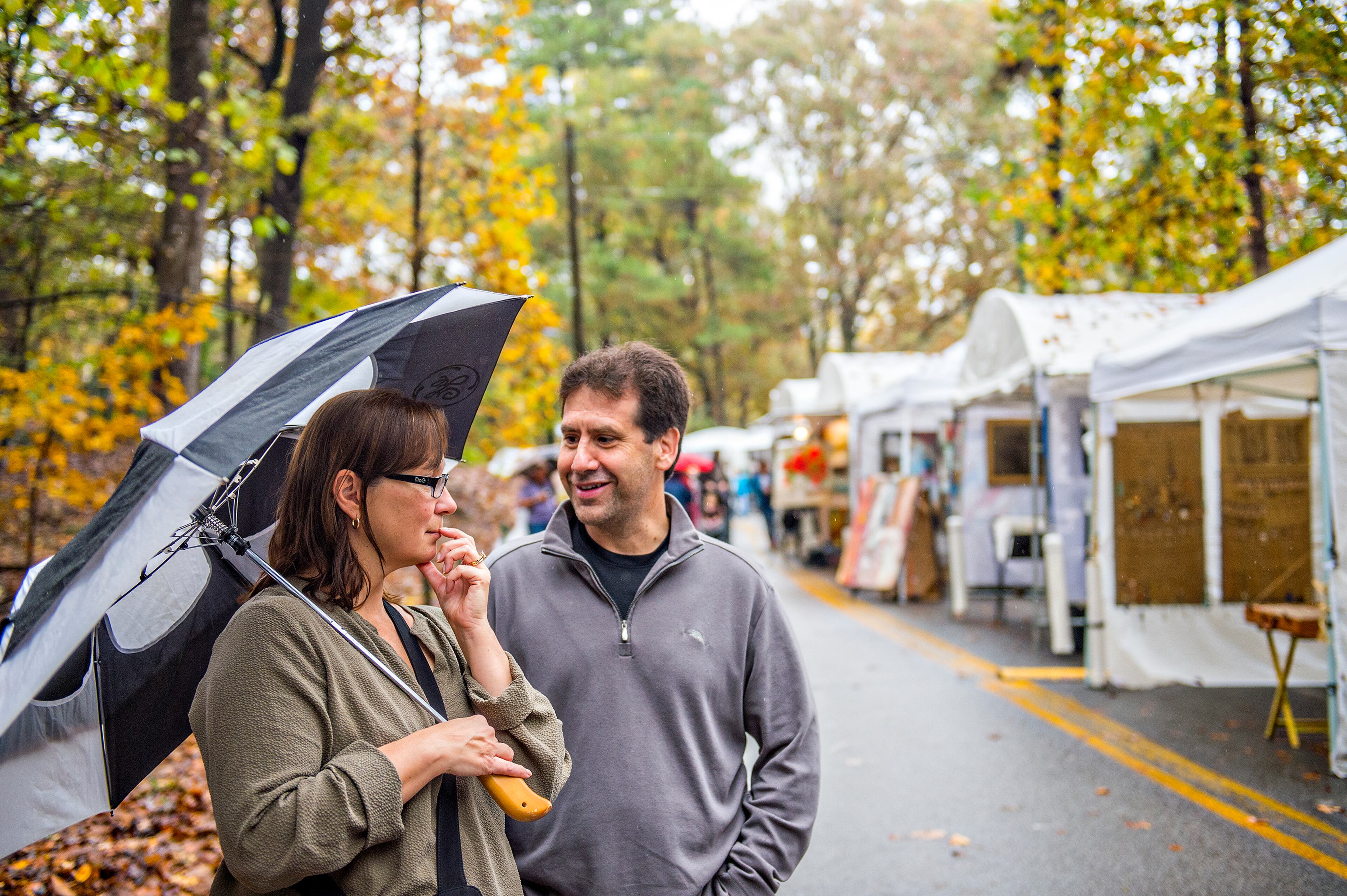 Jackie Bugica (left) and her husband Joe discuss a piece of art during the Chastain Park Arts Festival on Saturday, November 7, 2015. Rainy weather would not stop the two day festival featuring 185 artists. JONATHAN PHILLIPS / SPECIAL