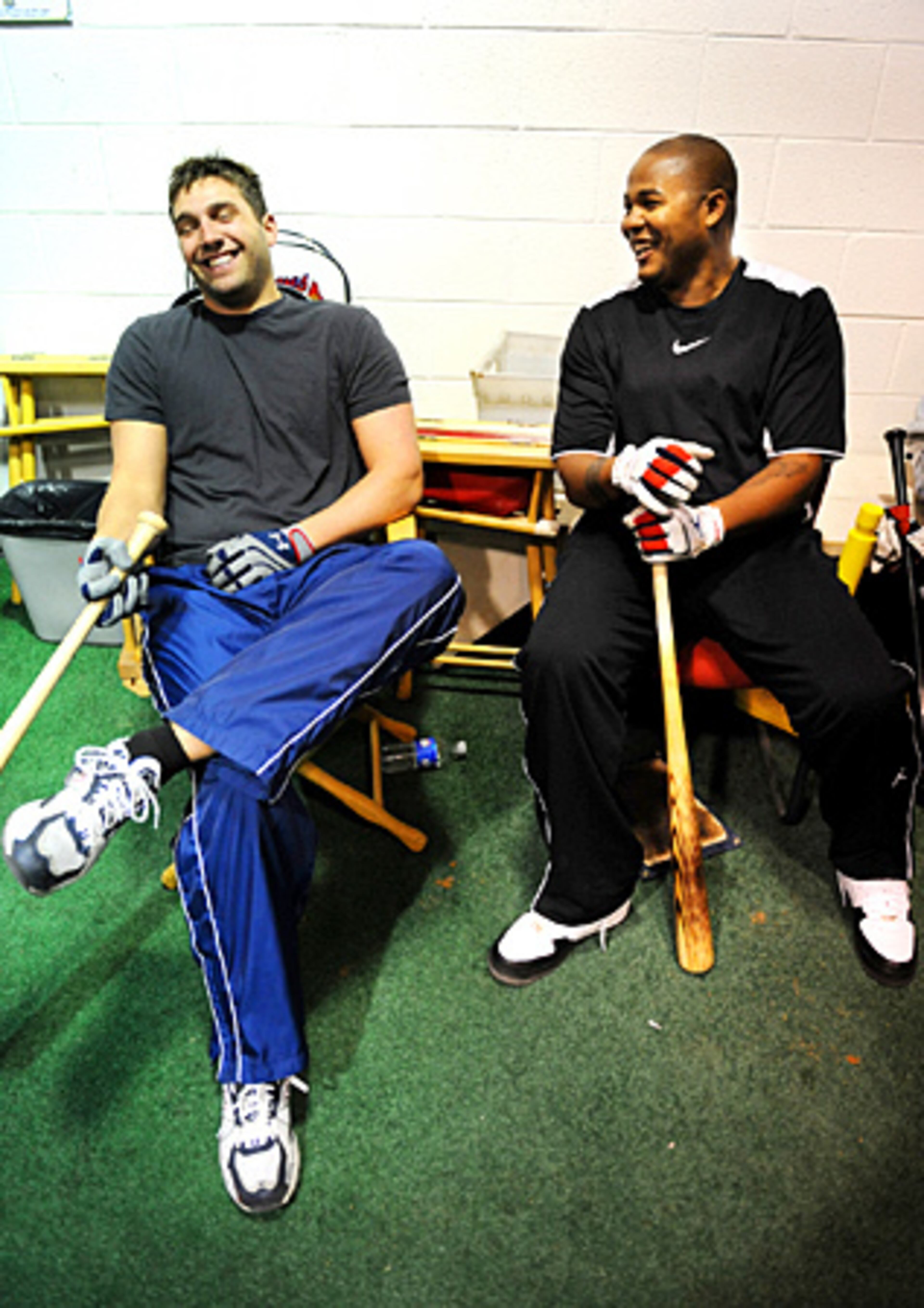 Dodgers' Andruw Jones (right) has a laugh with Braves Jeff Francoeur while waiting between batting sessions.