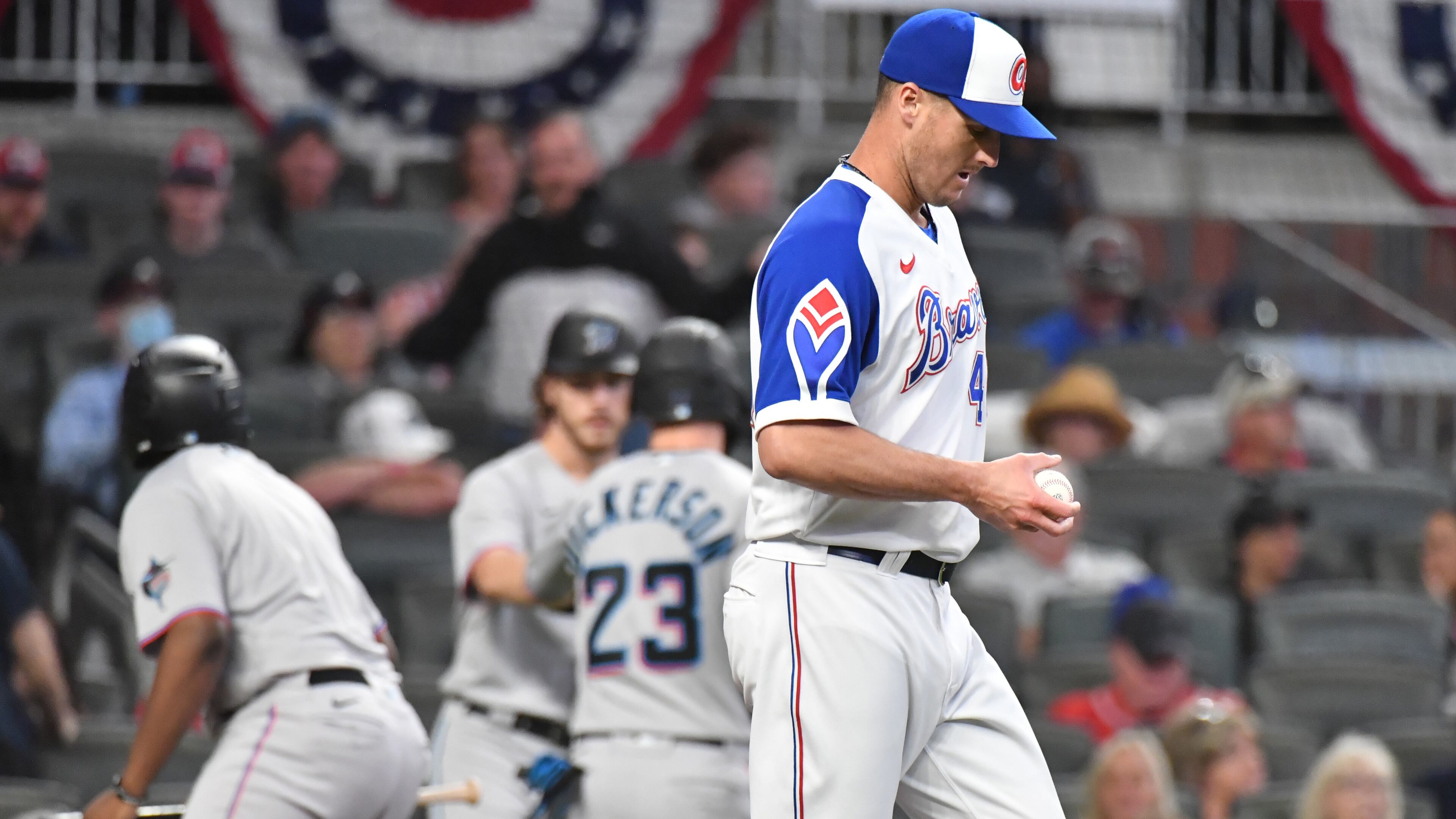 Braves reliever Nate Jones (49) reacts after allowing a two-run double by Marlins first baseman Garrett Cooper (26) in the 8th inning of Monday's game at Truist Park. The Braves blew a two-run lead before falling 5-3 in 10 innings.