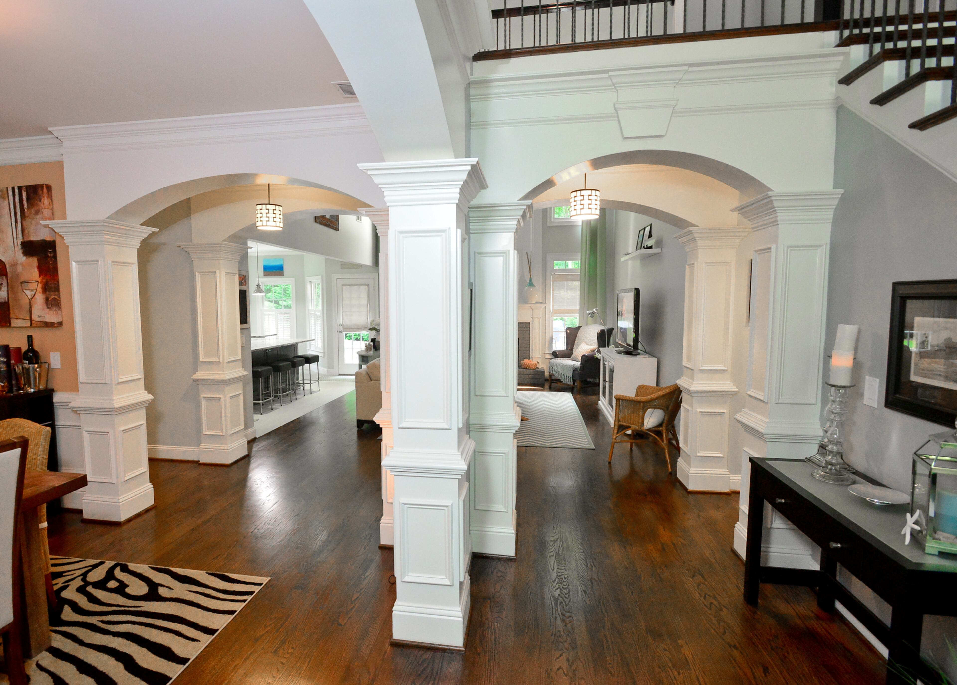 Extensive moldings are traditional elements in the Marietta home, built in 2003. The white details and walls painted Pewter Mug (Behr Premium Plus) stand out with the hardwood floors, which Moore Contract Services refinished and stained a darker color.