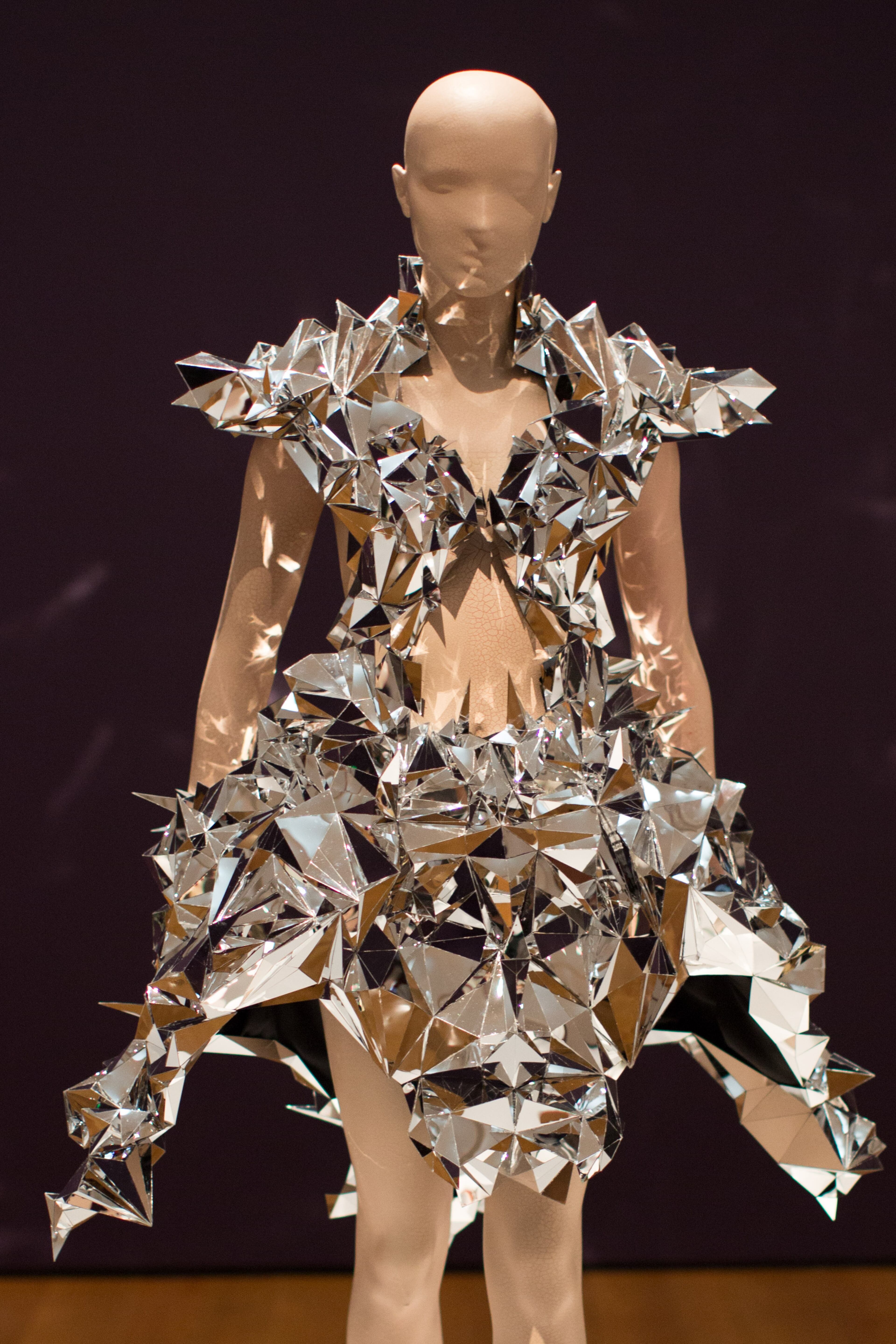 A dress from the Voltage collection by designer Iris van Herpen is displayed at the High Museum's new exhibit, "Iris van Herpen: Transforming Fashion," Thursday, Nov. 5, 2015, in Atlanta. The exhibit, running through May 15, shows the evolution of van Herpen's design from collections created from 2008 through 2015. Van Herpen is known for creating high-tech fabrics and fashions that combine materials like steel and silk with everyday objects like magnets and umbrella parts. (AP Photo/Branden Camp)