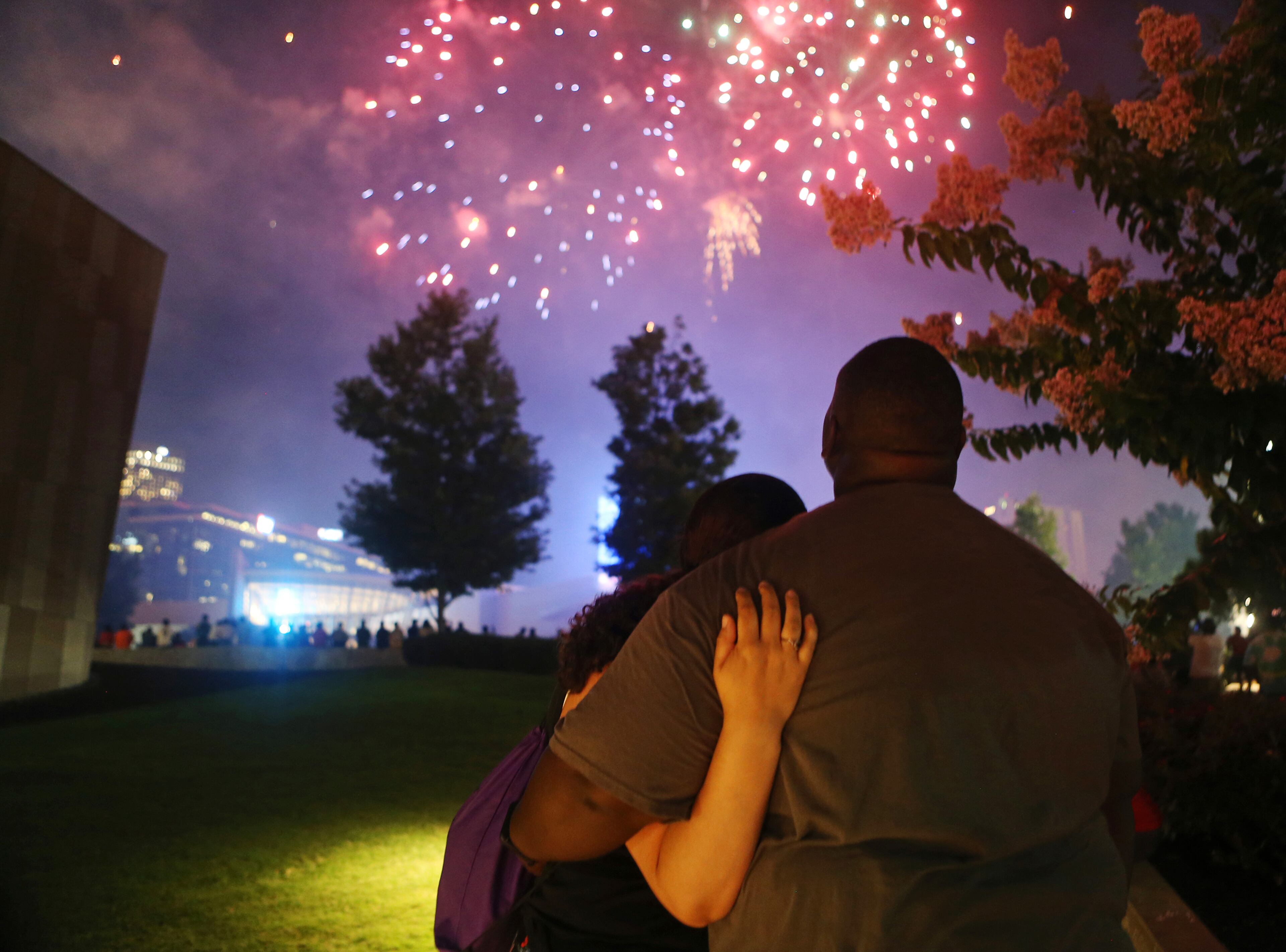 A man and woman embrace while watching the fireworks. Christina Matacotta/Christina.Matacotta@ajc.com