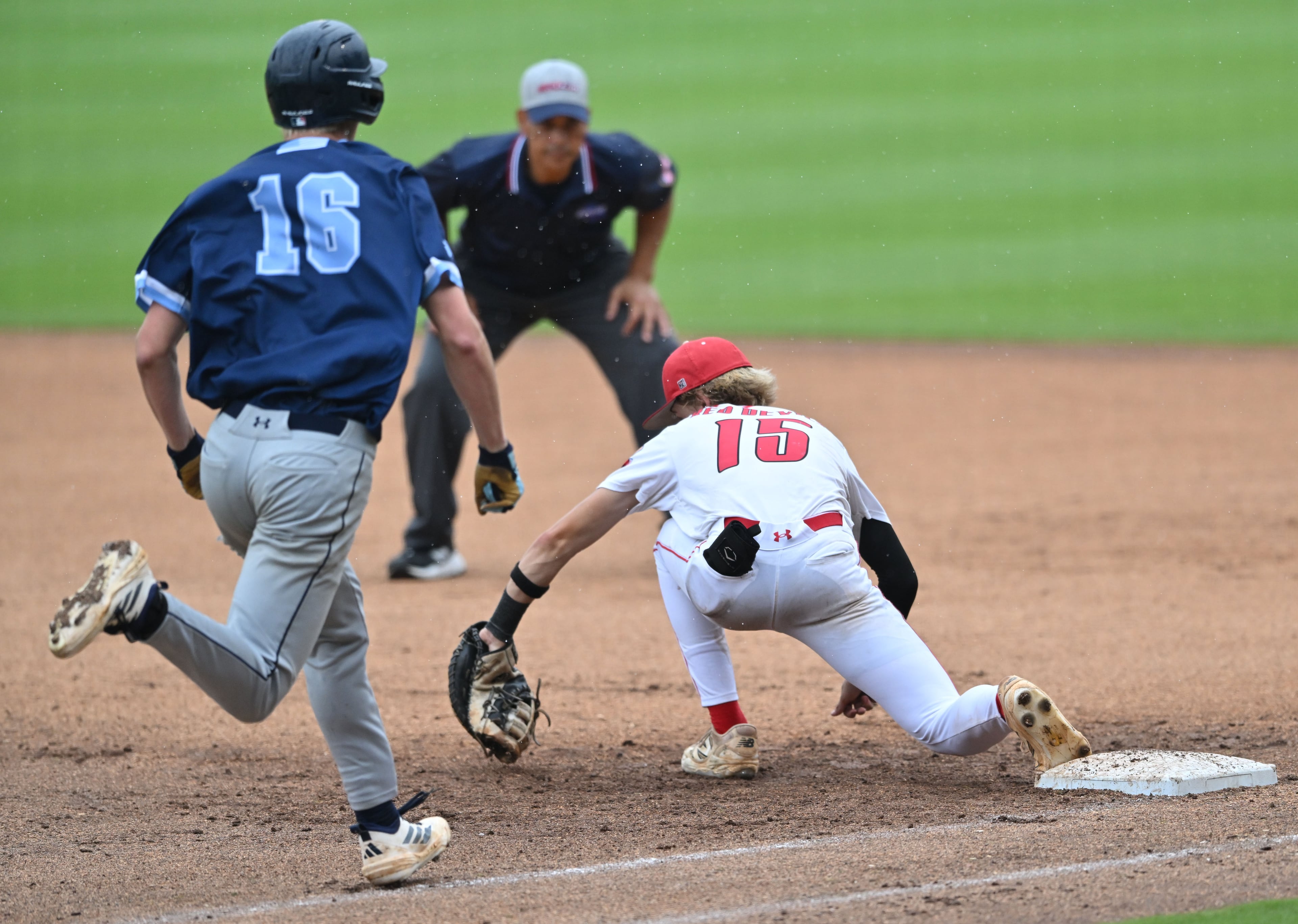 Loganville's Zac Cuneio (right) puts out Pope's Cal Pearson for the final out in Game 1 of the GHSA Class 5A baseball state championship series Monday, May 25, 2026, at Gwinnett Field in Lawrenceville. (Hyosub Shin/AJC)