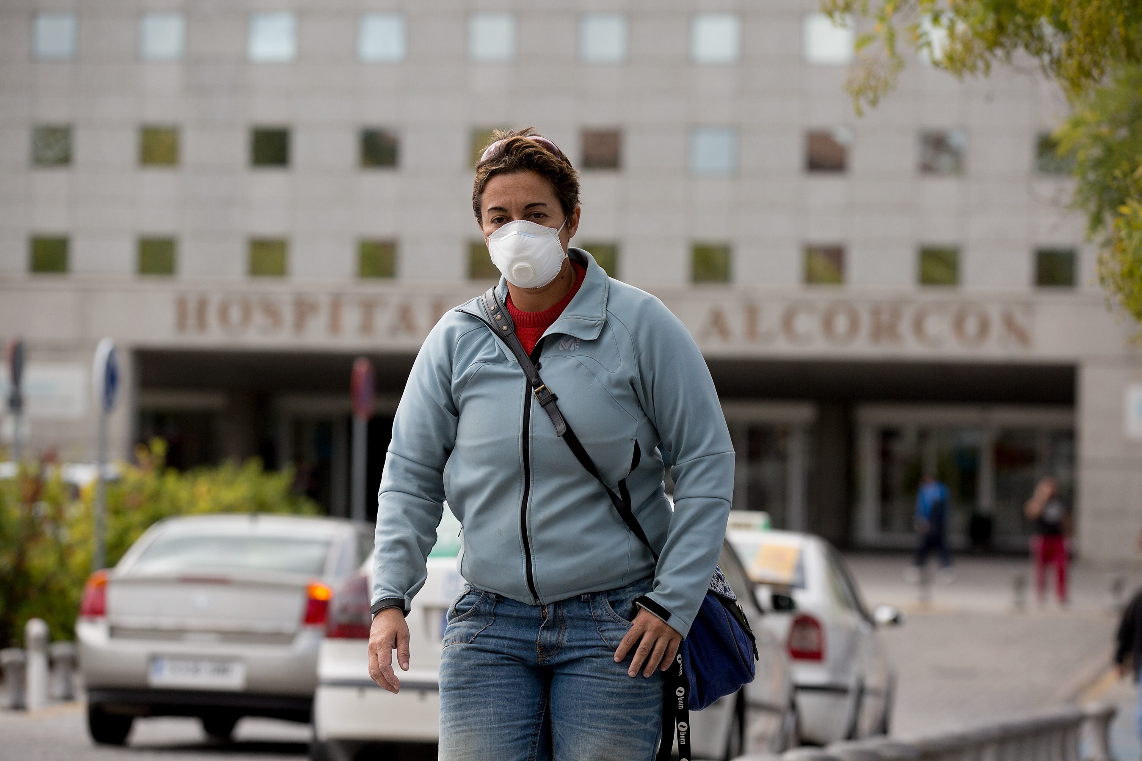A woman wears protective mask as she leaves Hospital Fundacion Alcorcon where a Spanish nurse tested positive for the Ebola virus on October 7, 2014 in Alcorcon, near Madrid, Spain. Spanish Health Minister Ana Mato confirmed the nurse had tested positive after treating two Ebola patients that had been brought back to the country from Africa. (Photo by Pablo Blazquez Dominguez/Getty Images)